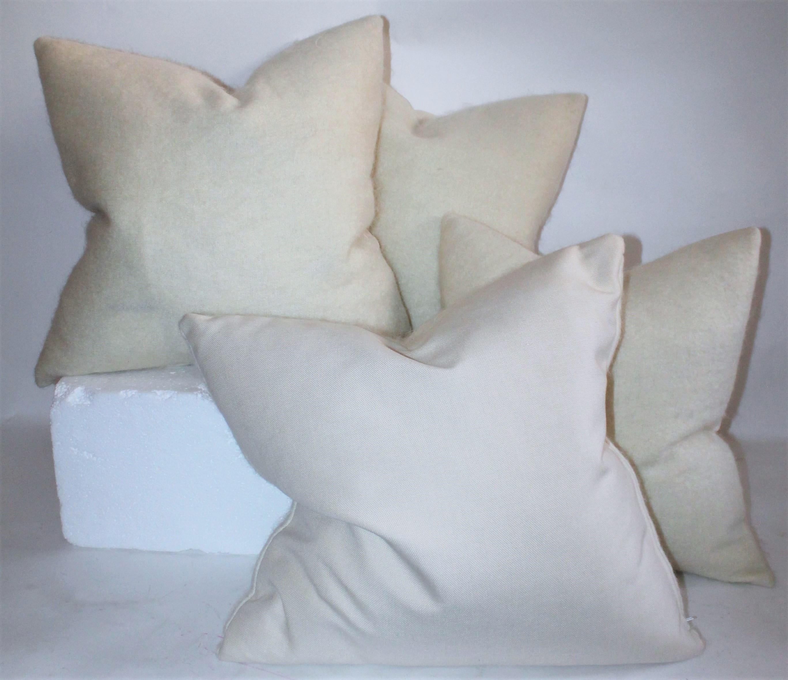 Collection of four cream mohair pillows with linen pillows. These soft lambs wool pillows are in pristine condition. There are two different sizes.

Larger pillow measures 22 x 22 
Smaller pillow measures 20 x20.