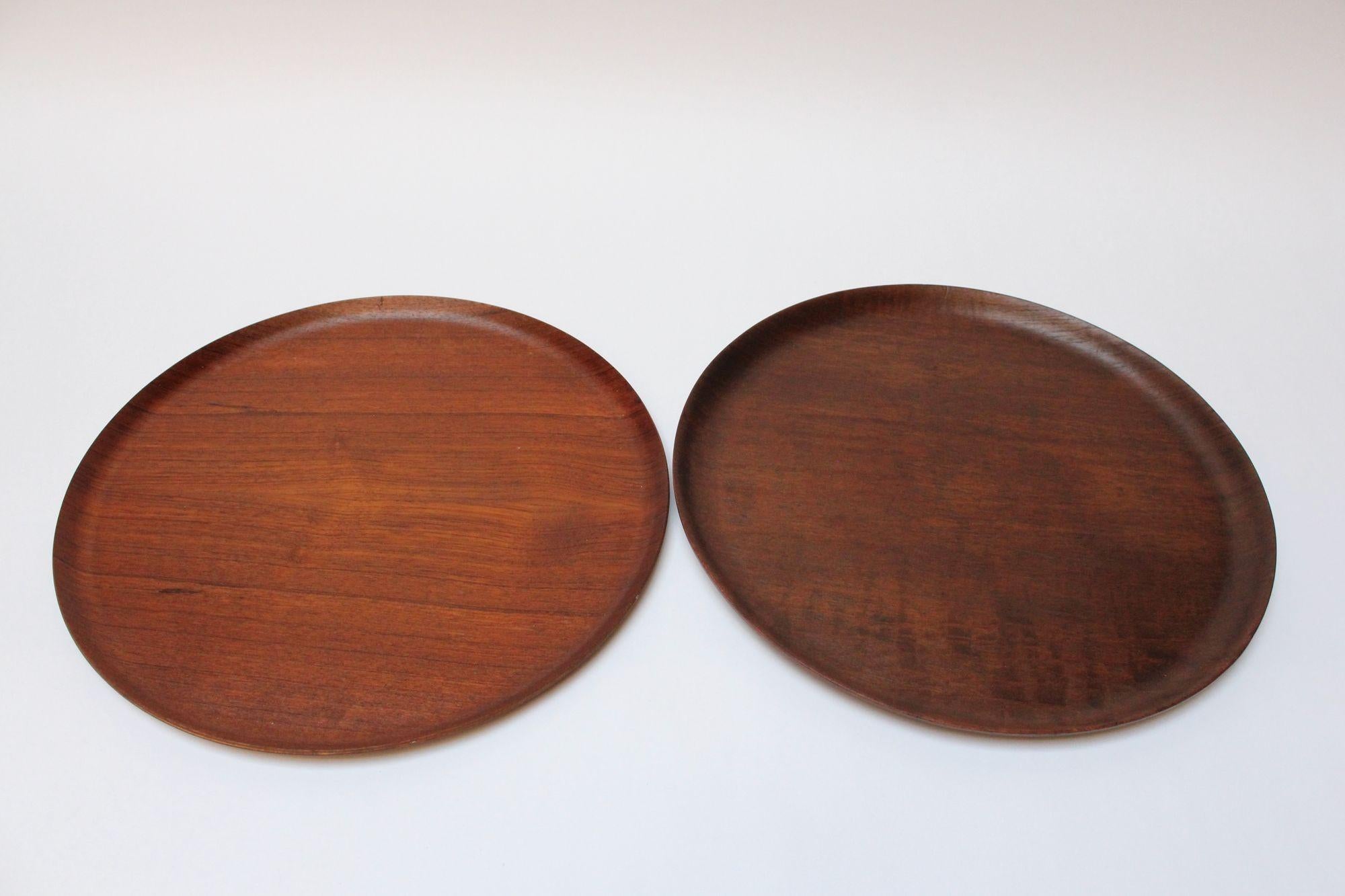 Set of four similar Swedish teak trays with curved edges, ca. 1960s. Slight variations in grain, color, and size (diameters range from 17.25