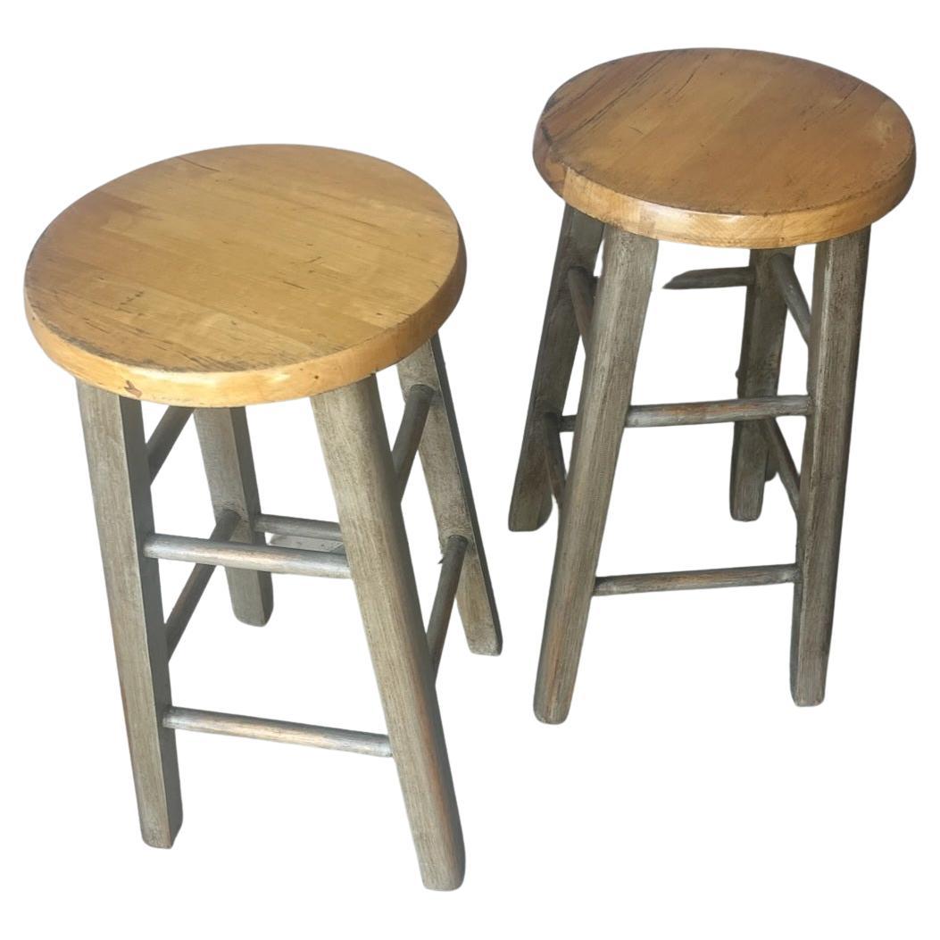 Amazing and sturdy bar stools in old original painted surface with a natural surface tops. Sold as a collection of four stools,One pair is slightly different from the other pair.Great assembled set of four stools.