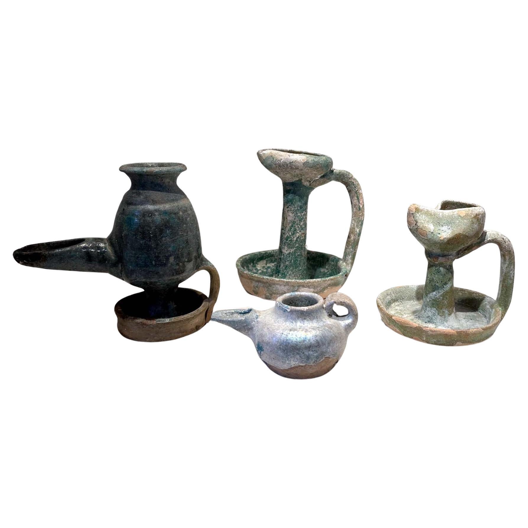 Collection of Four Persian Glazed Ceramic Oil Lamps For Sale