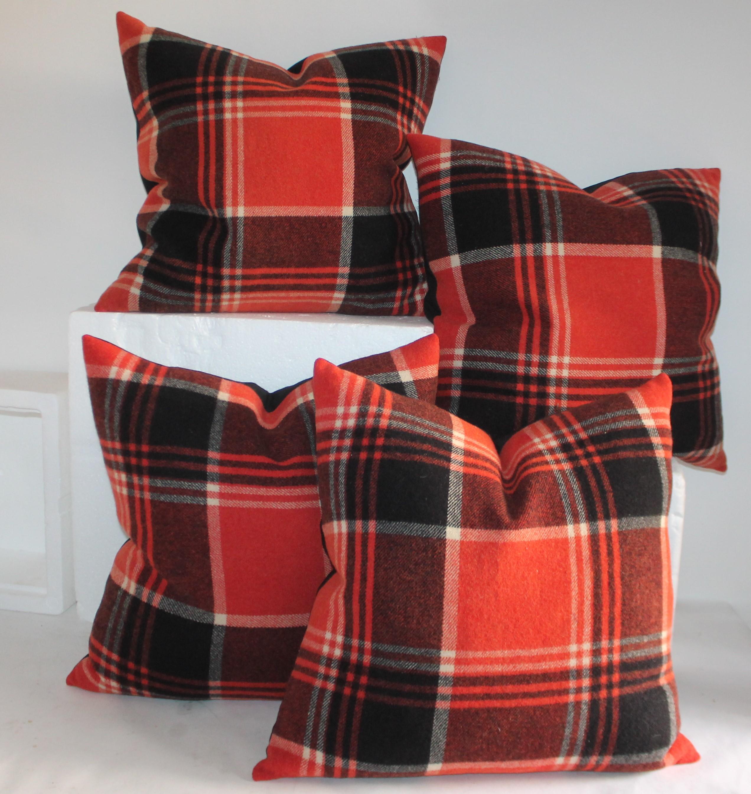 Collection of four black and red plaid pillows in great condition. The textiles were pulled from a vintage camp blanket made from wool. Beautiful pattern to the pillow with a vintage linen backing.