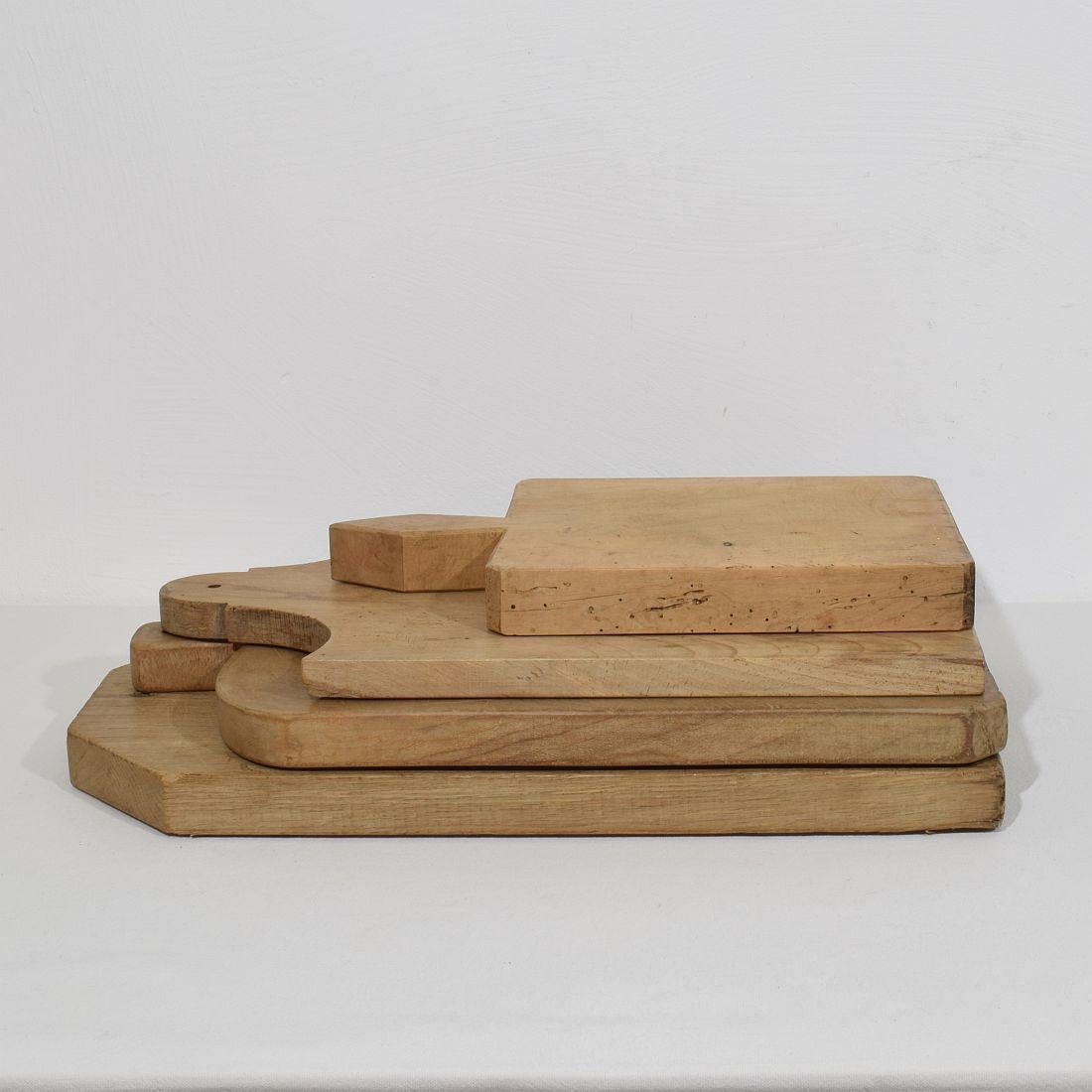Beautiful  collection of four wooden chopping-cutting boards. Great statement on your counter-top,
France, circa 1850-1900. Weathered. Measures: H:39-54cm  W:23-31cm D:2,5-4cm   . Measurement here below of the largest cutting board. More pictures