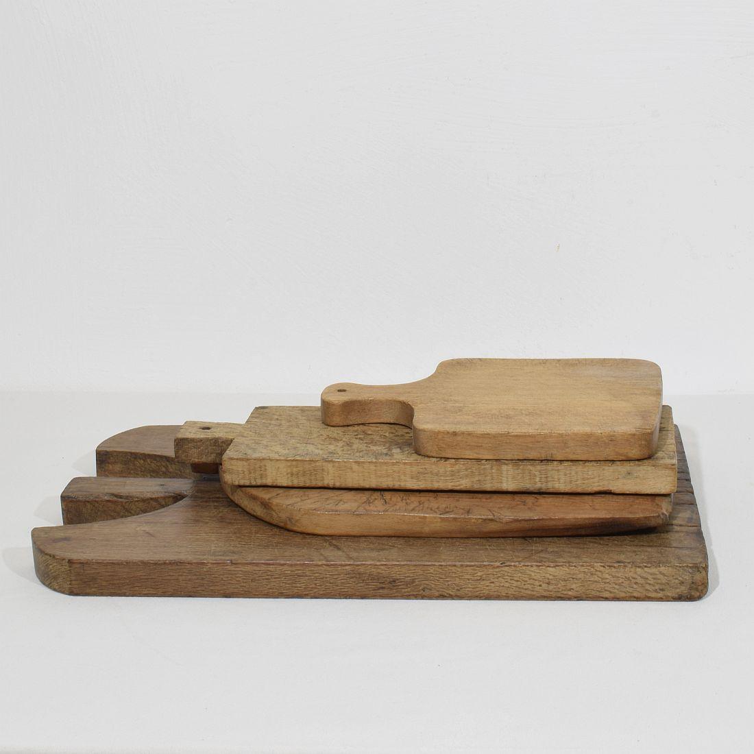 Beautiful  collection of four wooden chopping-cutting boards. Great statement on your counter-top,
France, circa 1850-1900. Weathered. Measures: H:27-55,5cm  W:13-30cm D:2-3cm    . Measurement here below of the largest cutting board. More pictures