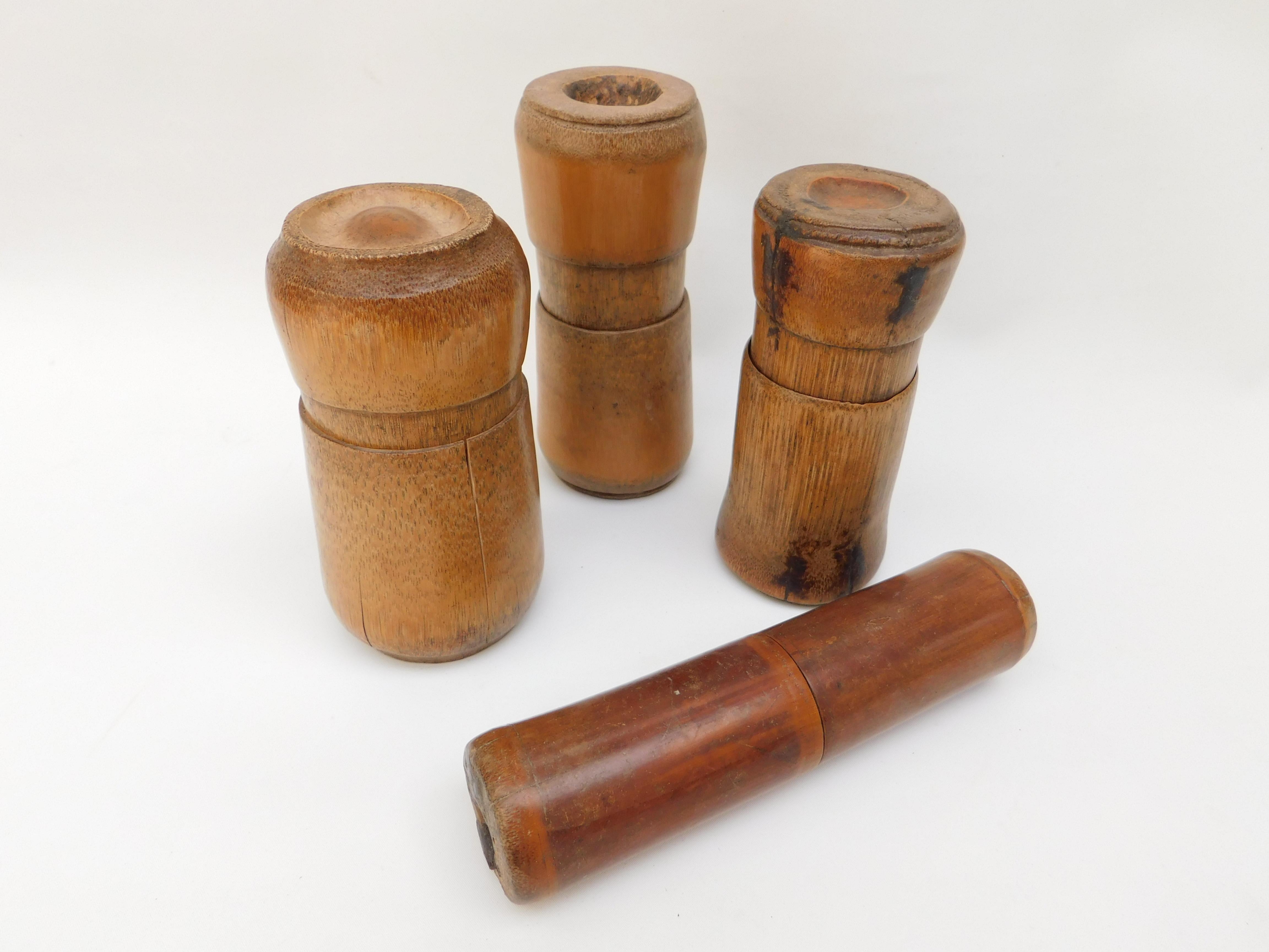A collection of four circa 1940 bamboo boxes from the South Pacific. The two part boxes are made from full bamboo stalks that twist together and seal to protect items such as documents, herbs and medicinal items. 
measurements (in centimeters)
14