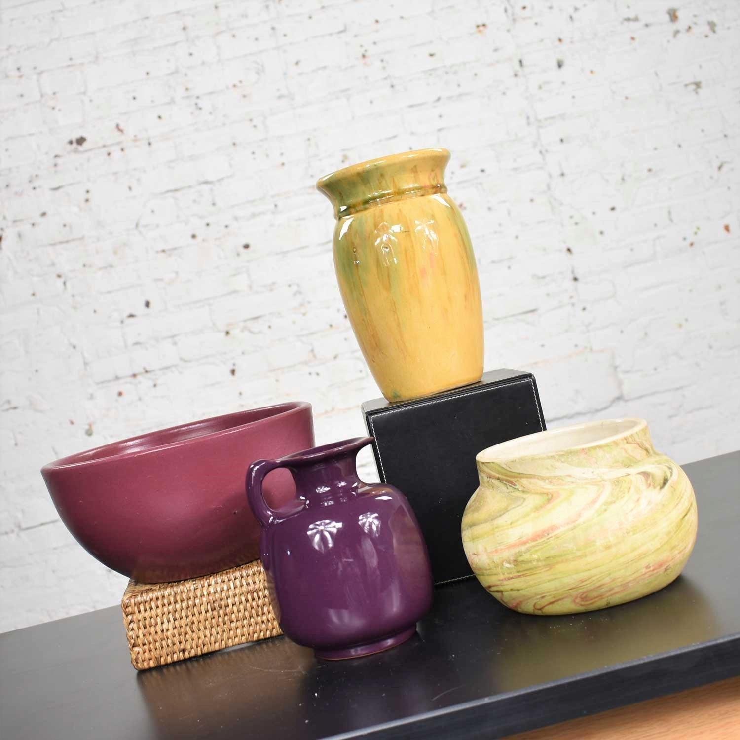 Handsome collection of four vintage pottery pieces including an aubergine bowl, Hull yellow vase, plum or eggplant Frankoma ewer, and a swirl green with purple pot. They are all in wonderful vintage condition with no chips, cracks, or chiggers. The