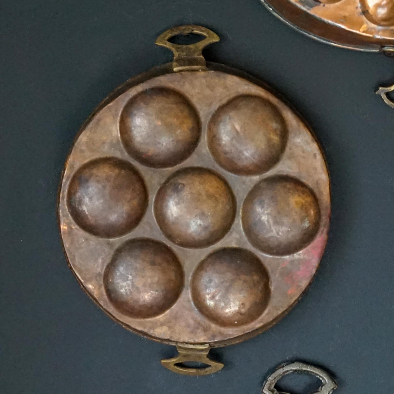 Collection of Fourteen 19th Century French Copper Egg Poacher or Escargot Pans For Sale 4