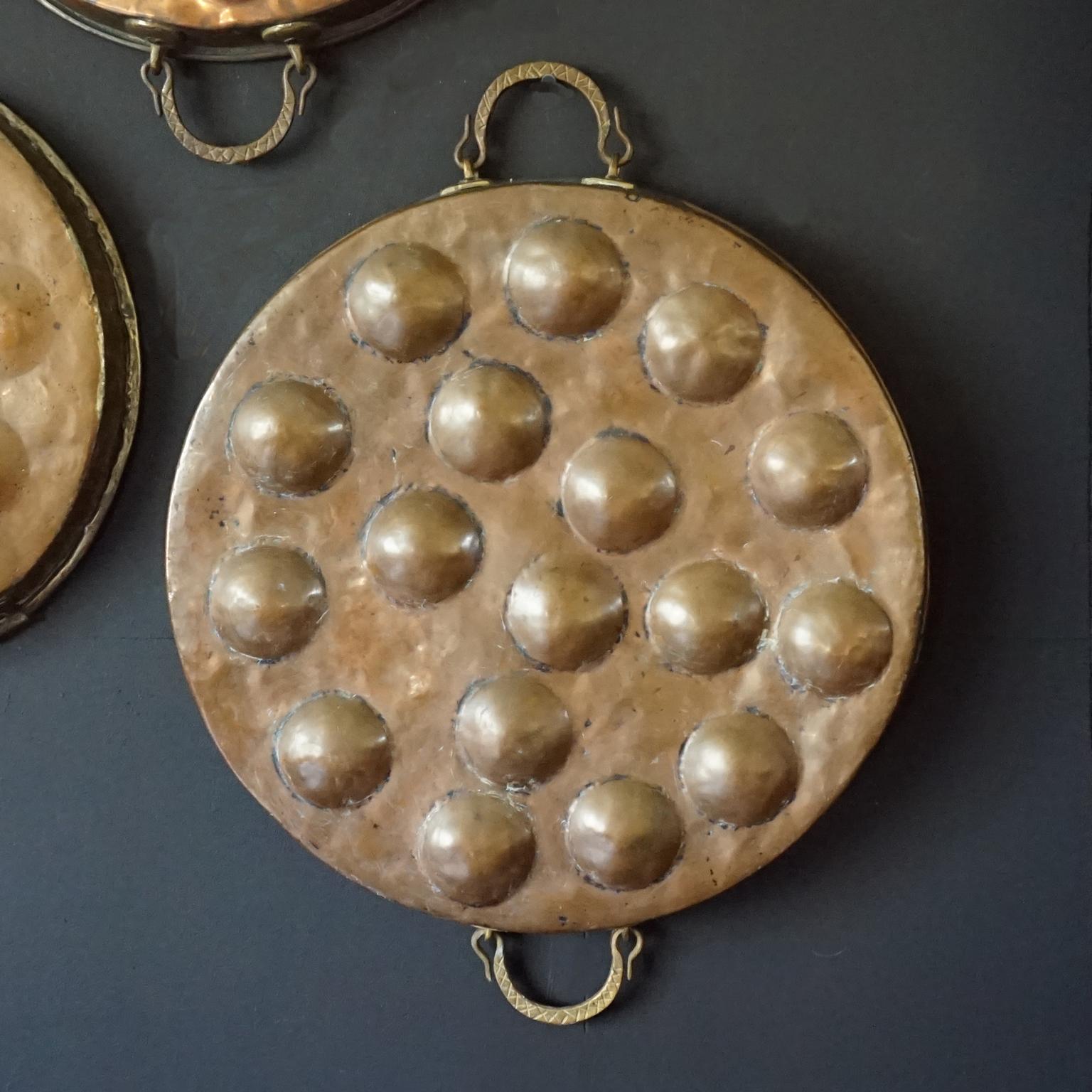 Collection of Fourteen 19th Century French Copper Egg Poacher or Escargot Pans For Sale 4