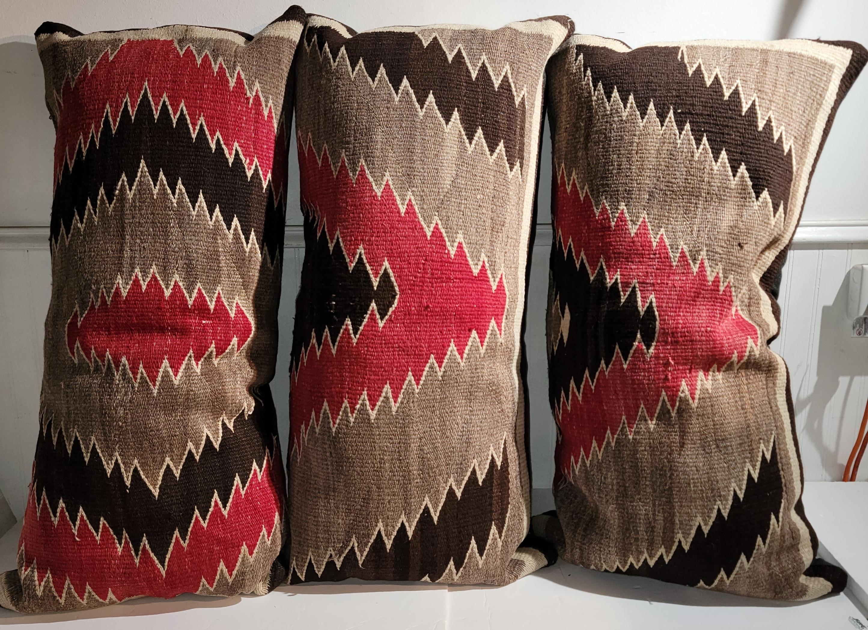 Collection of three Navajo Indian weaving geometric bolster pillows. The backings are in brown cotton linen & down & feather filled.
All three pillows measure the same. Sold as a collection.