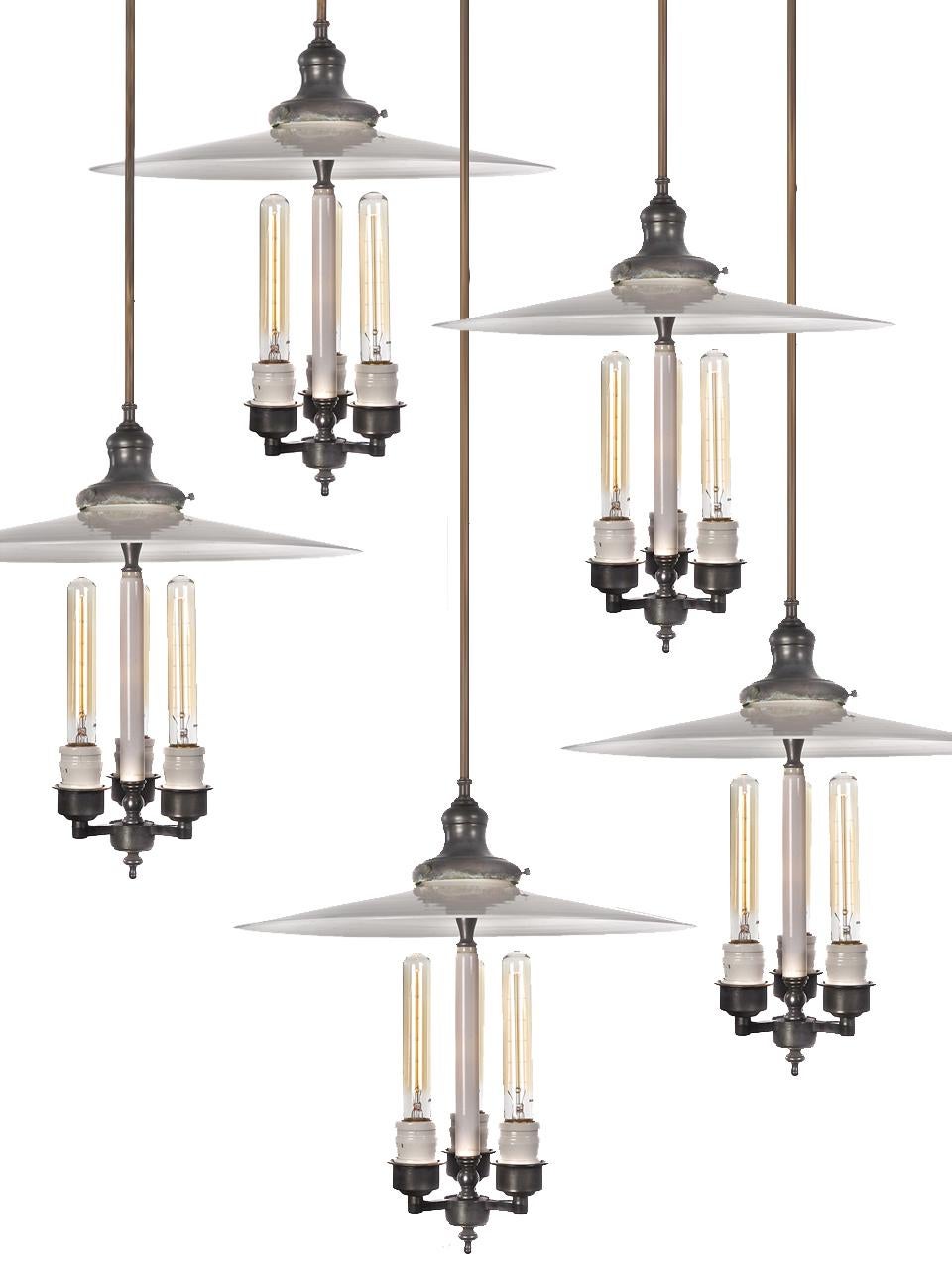 We have a nice collection if these three-bulb chandeliers. Because the large milk glass shades are hand blown there will be slight differences. The center pillar on each lamp is milk glass as well. That center works as an additional reflector and