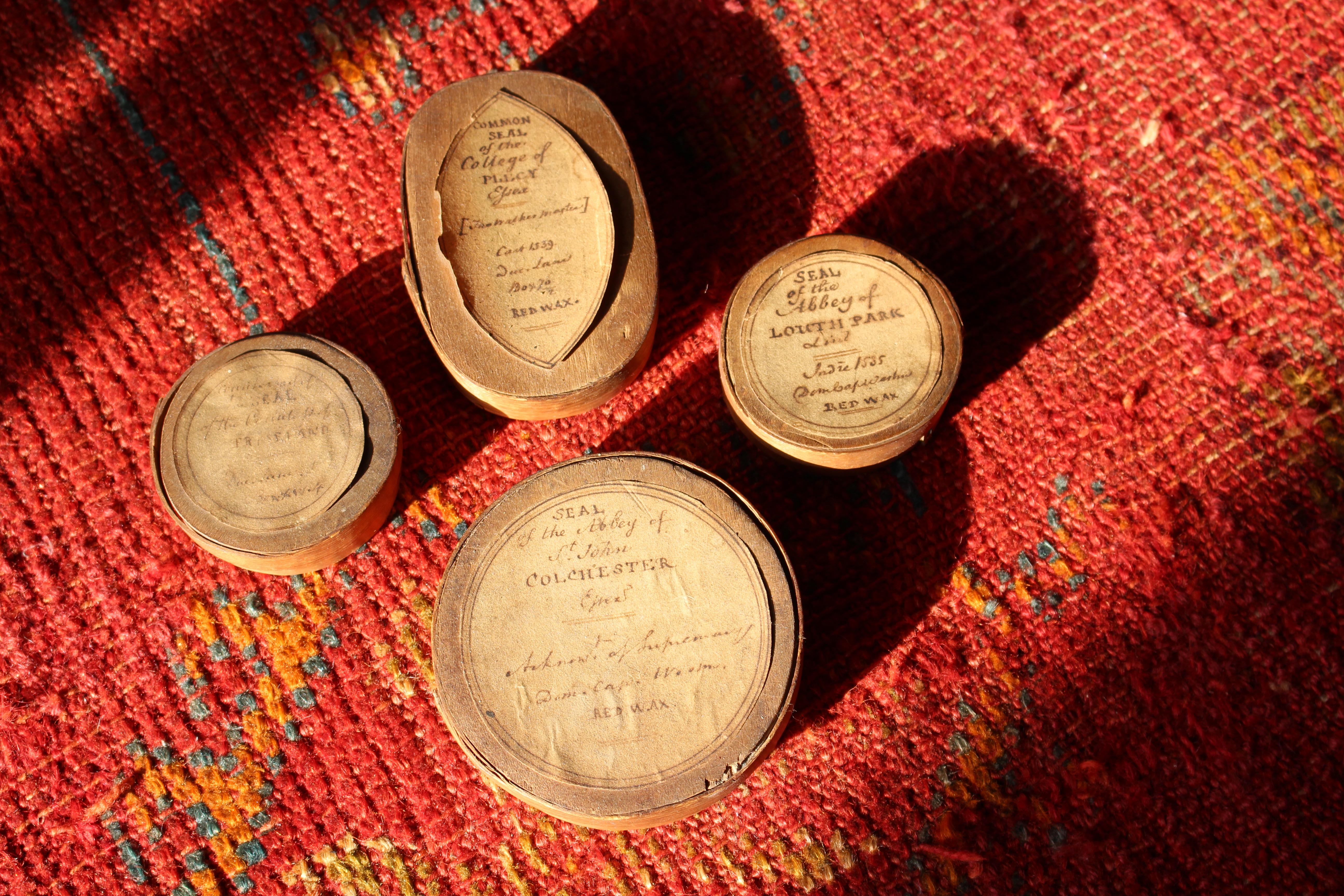 A collection of four late 18th century replica wax seals, encased in plaster and housed in softwood boxes. They also retain their original pointed oval and circular hand written labels, one is illegible the other three read as follows.

The 'Common