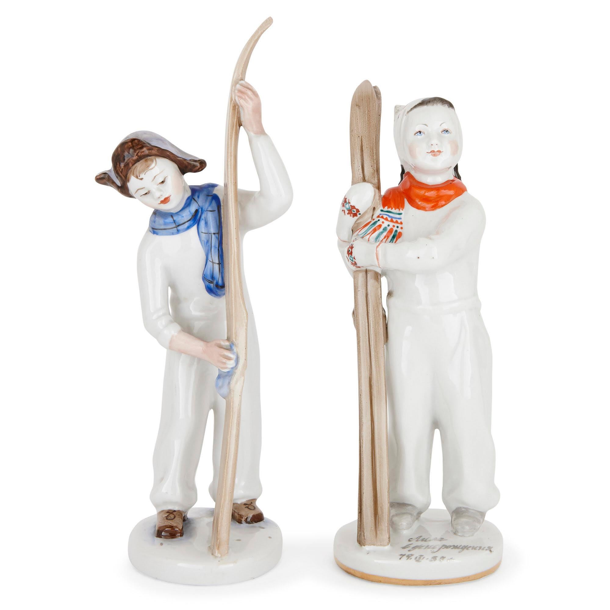 These delightful porcelain figurines were created in Russia in the 1950s. Included in this set are two models depicting a boy and girl holding skis, and a small figure of a boy playing ice hockey. These three figurines are marked on their undersides