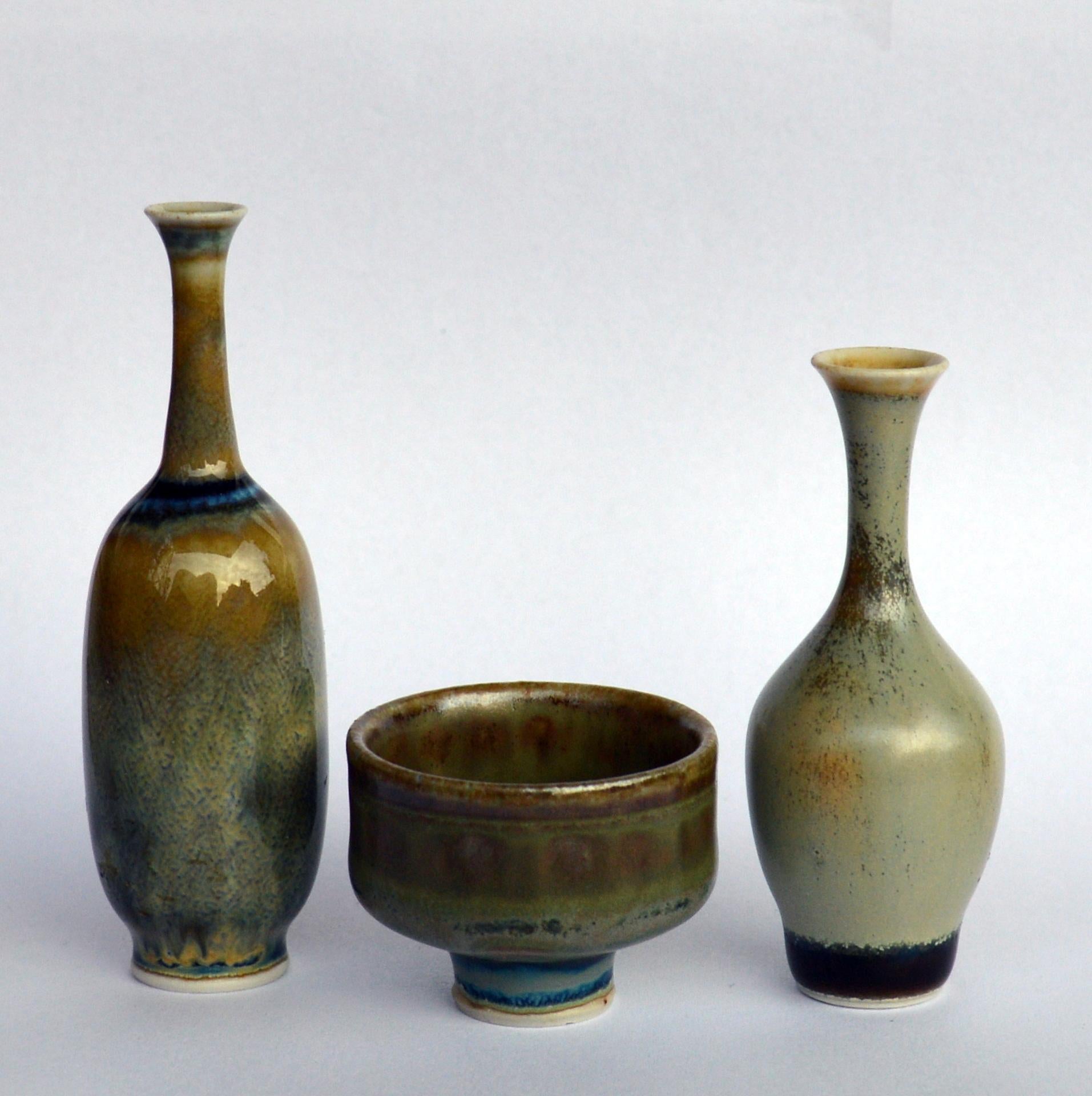 Wonderful collection of miniature ceramics. These ones are the work of John Andersson, signed ”JA”, and produced at Höganäs in Sweden. There are two vases and one bowl. The sculpture forms are amazing as well as the glaze. Measures: tallest vase are