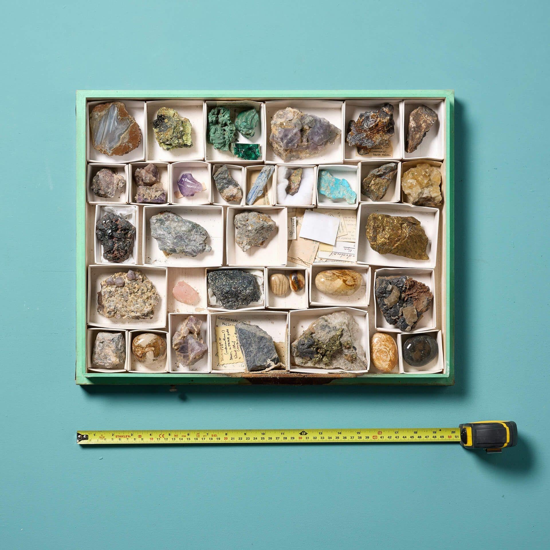 A collection of museum minerals in a display case. Presented in a sleek glazed case, the collection includes 38 European minerals, including amethyst and pyrite, all with their own striking appearance. Each mineral is of a superb quality and worthy