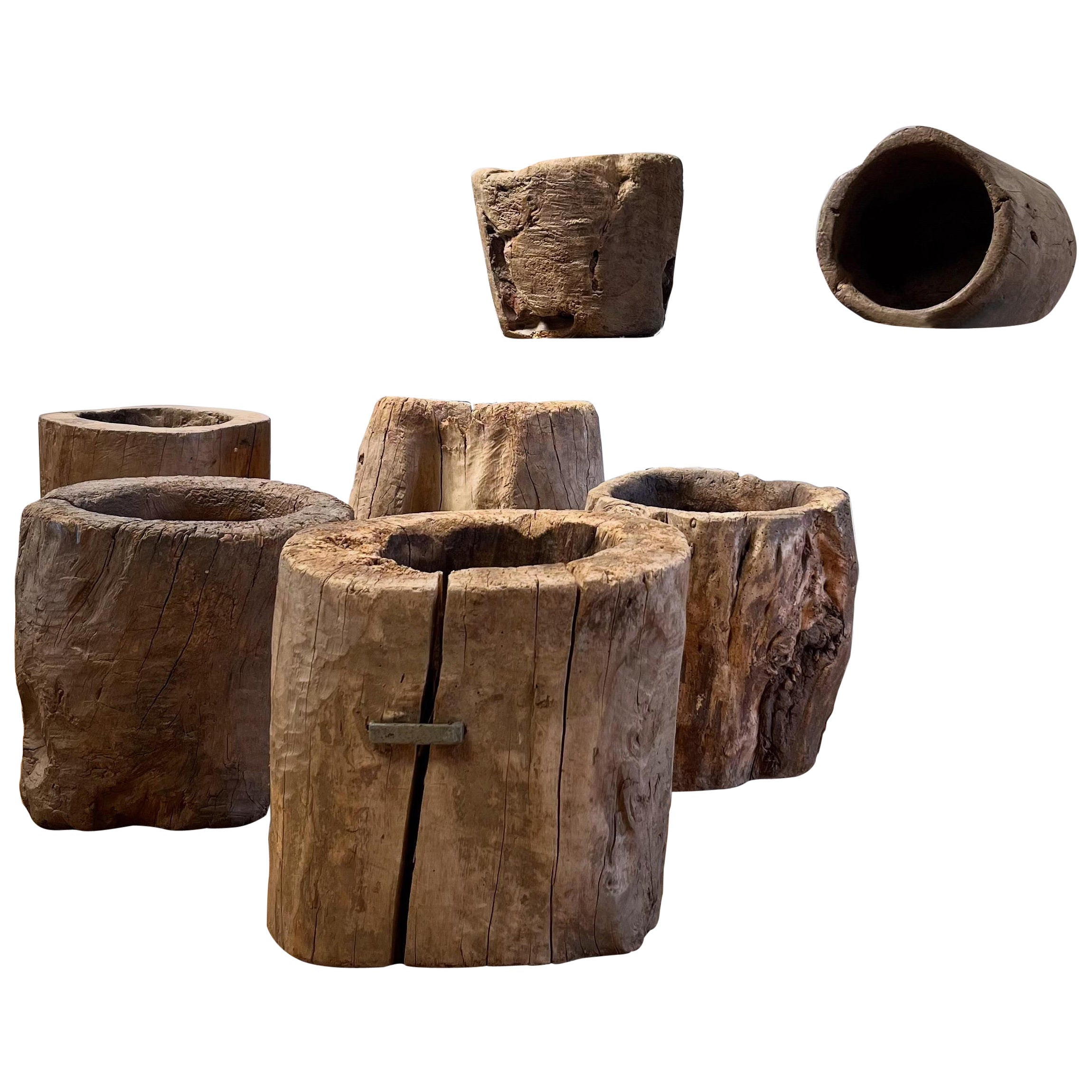 A collection of mortars, single pieces of elm hollowed out and softened by years of use - seven in total

Asian, Mid Nineteenth Century

H 41.5  /  32 x W 36  /  26 cms 