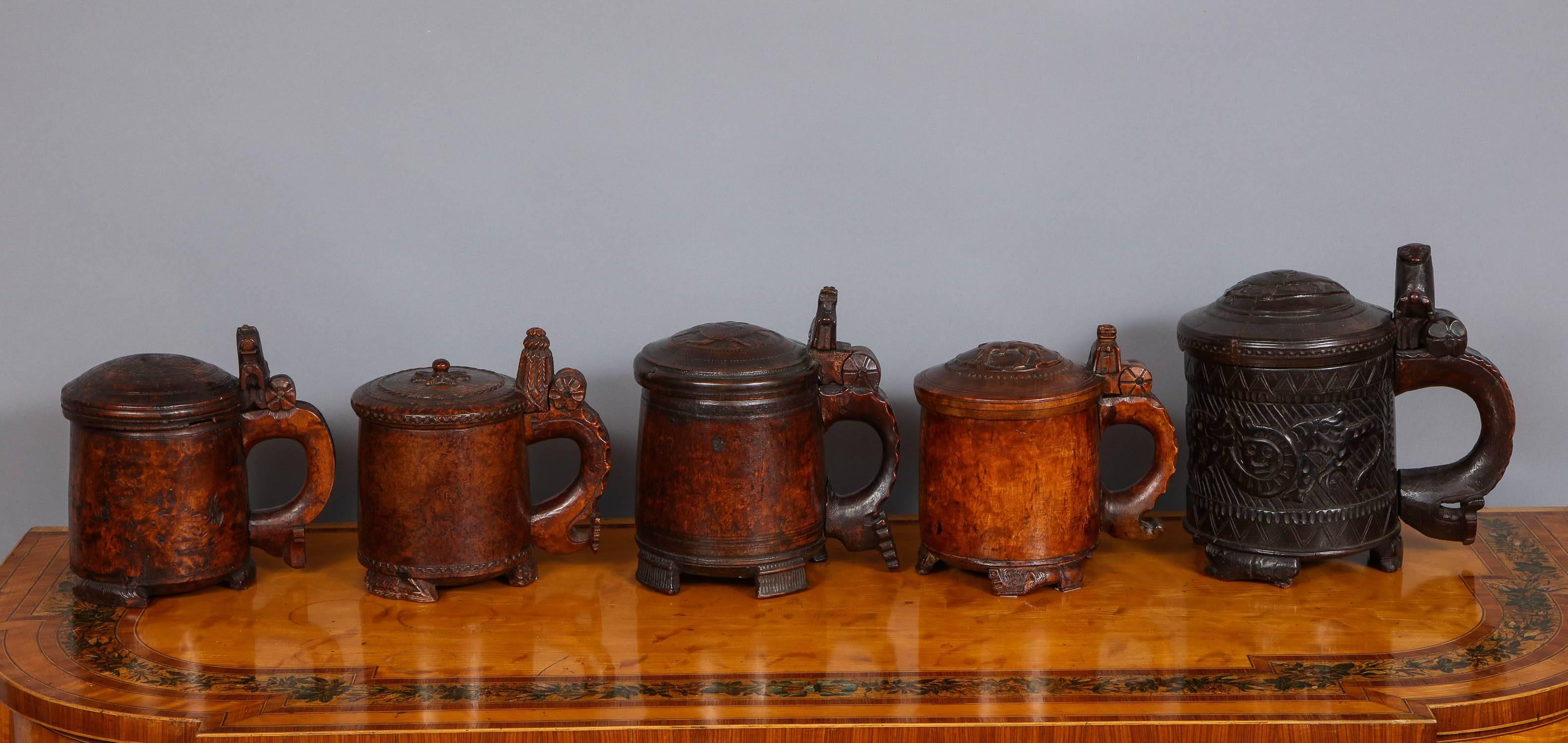 Fine collection of Norwegian peg tankards, circa 1770-1820, most with lion carved handles, all but one fashioned from burl birch wood and all possessing good rich color. The largest is unusual not just for the scale, but additionally for the Nordic