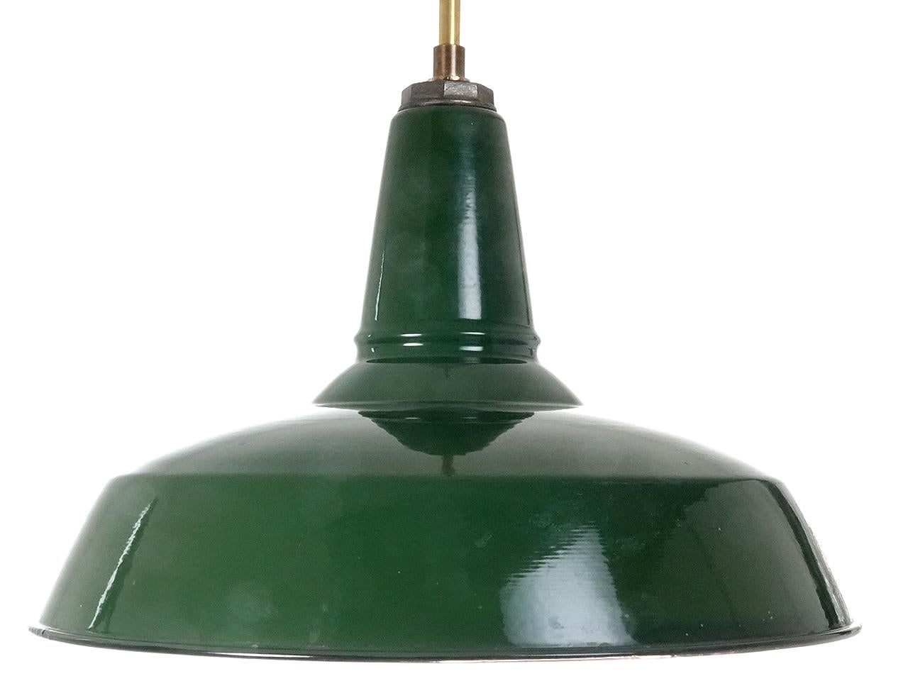 This was an amazing barn find. These classic shape industrial lamps are green over an antique white porcelain finish. The 18 inch diameter dome is impressive and the condition is beautiful. The shade holder is signed Benjamin... one of the most
