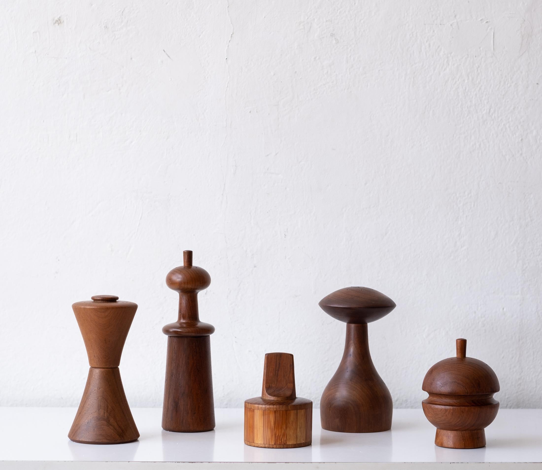 Collection of five teak pepper mills by Jens Quistgaard. Early metal grinding mechanisms produced by Peugeot. The mills were produced by Dansk in Denmark and one in Thailand (round one). Circa 1960s.