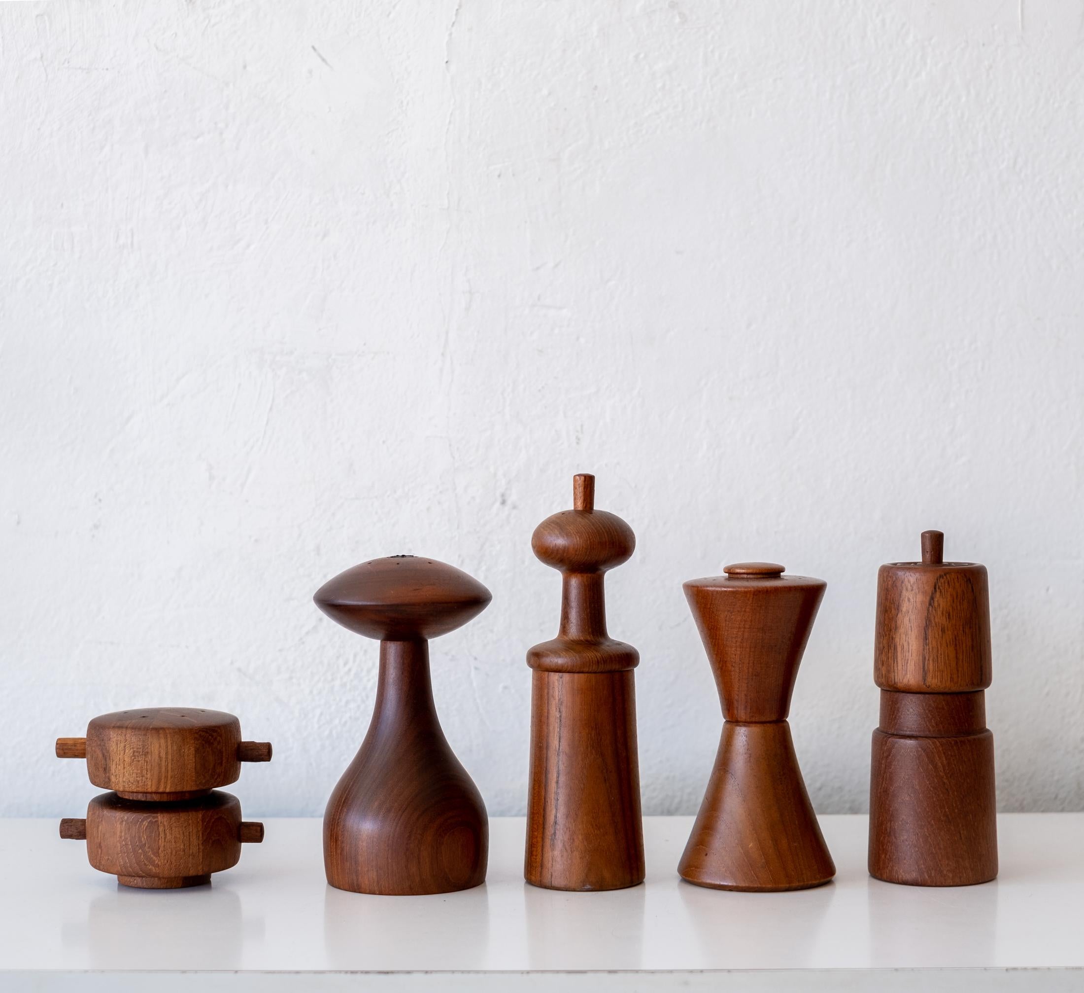 Collection of five teak pepper mills by Jens Quistgaard. Early metal grinding mechanisms produced by Peugeot. All mills were produced by Dansk in Denmark. Circa 1960s.