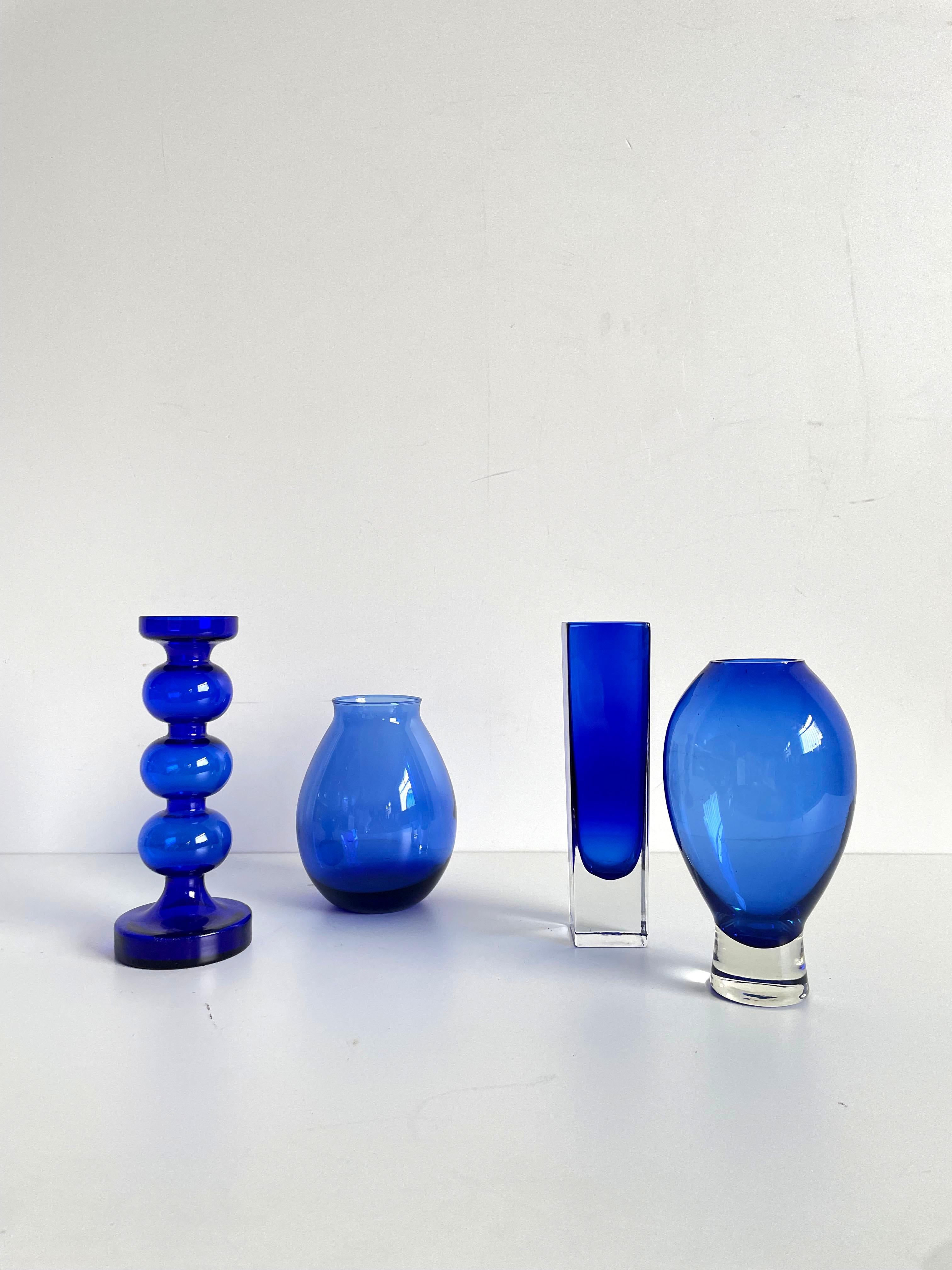Beautiful set of 4 different Mid-century Scandinavian art glass vases in blue color

One of the vases is designed by Alfred Taube (Germany), attribution for other 3 vases is unknown. 

Dimensions:
tall square shaped vase measures  22 x 5.5 x 5.5 cm