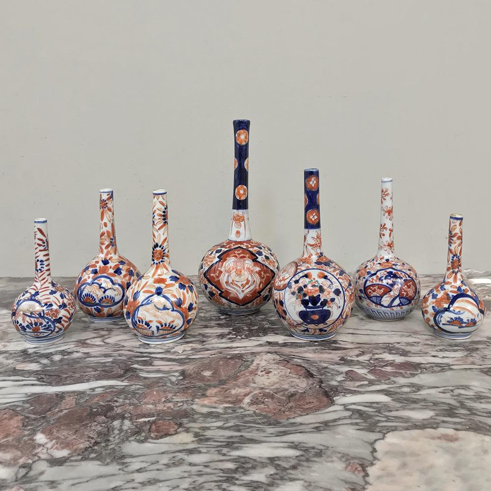 Collection of seven 19th century Imari bud vases display remarkable artistry in the hand painted, cobalt blue and copper red embellishment, and represent years of collecting acumen! Priced as a complete collection,

circa 1880s

Sizes range from