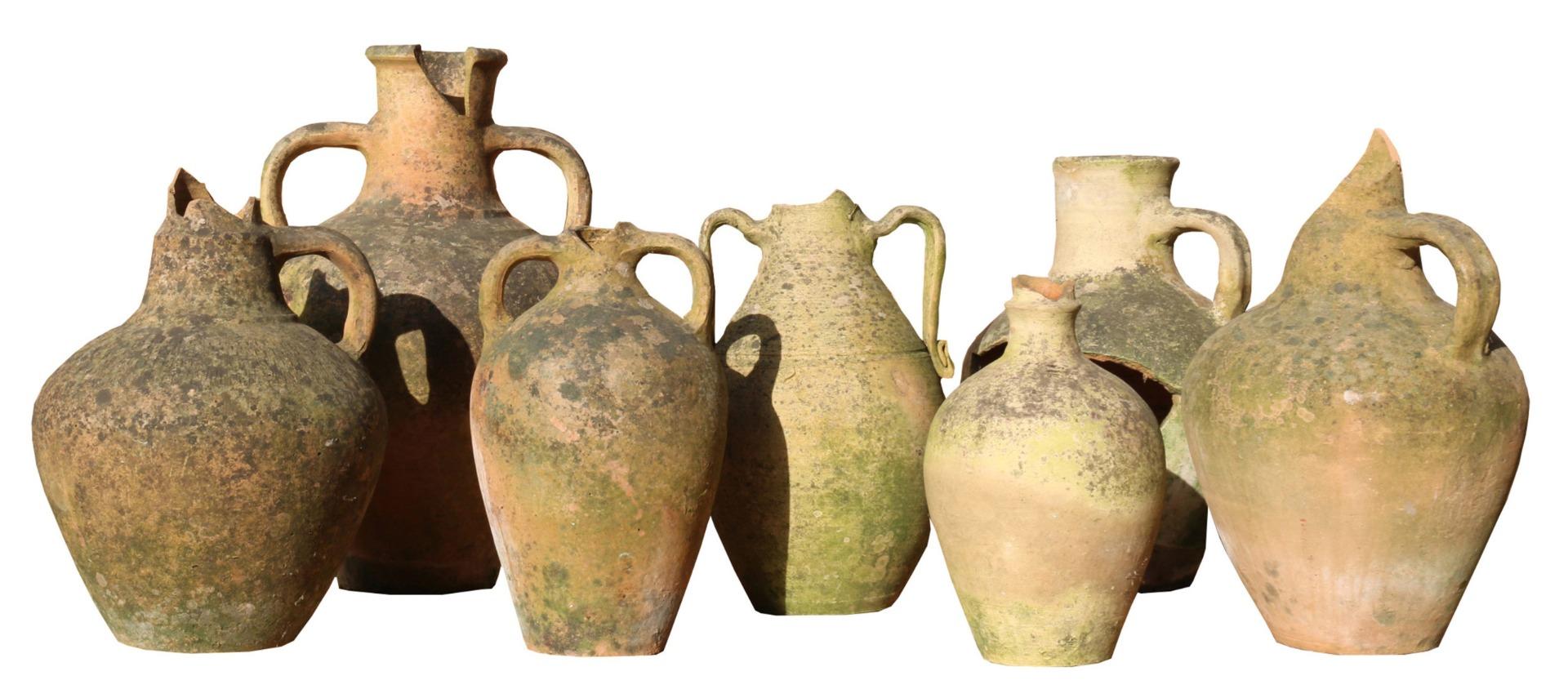 A collection of seven characterful weathered Mediterranean food storage or olive jars.

Measures: height (largest ) 45.5 cm to (smallest) 27.5 cm

diameter (largest) 28 cm (smallest) 17 cm approx.
