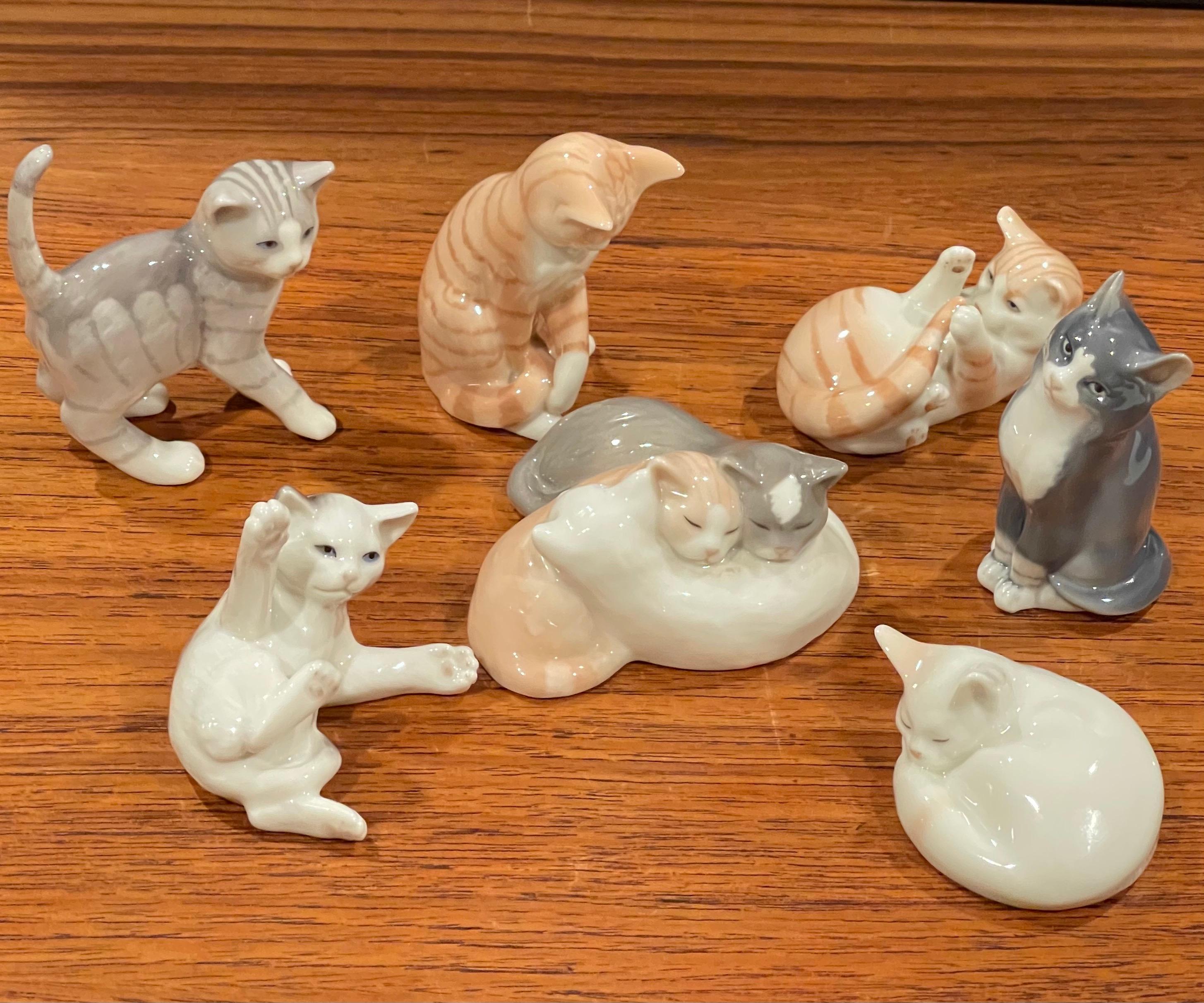 Collection of seven miniature porcelain cat sculptures by Royal Copenhagen, circa 1970s. The cats are in very good vintage condition with no chips or cracks and measure approximately 3