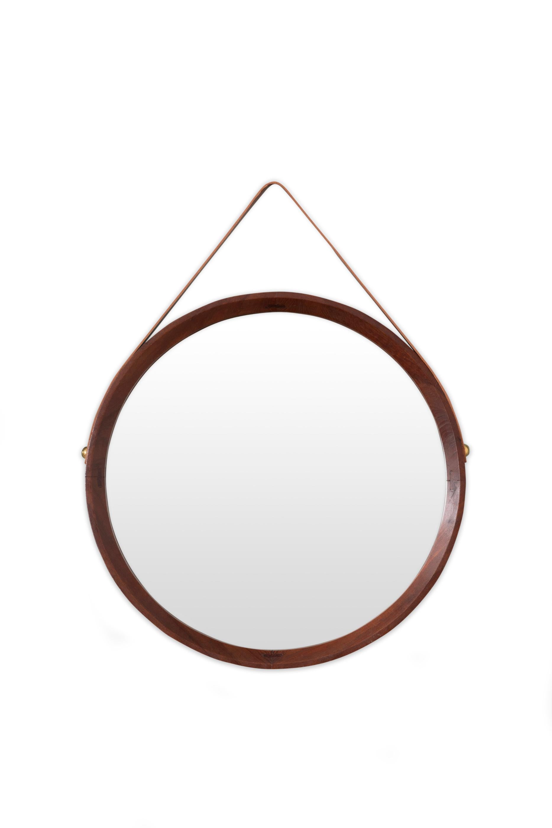 A collection of seven elegant wall mirrors.
These mirrors can be displayed in many different combinations to create a stylish wall decoration.
Walnut frames, held with leather straps (replaced). 
Italy, circa 1960. 

Sizes (excluding leather