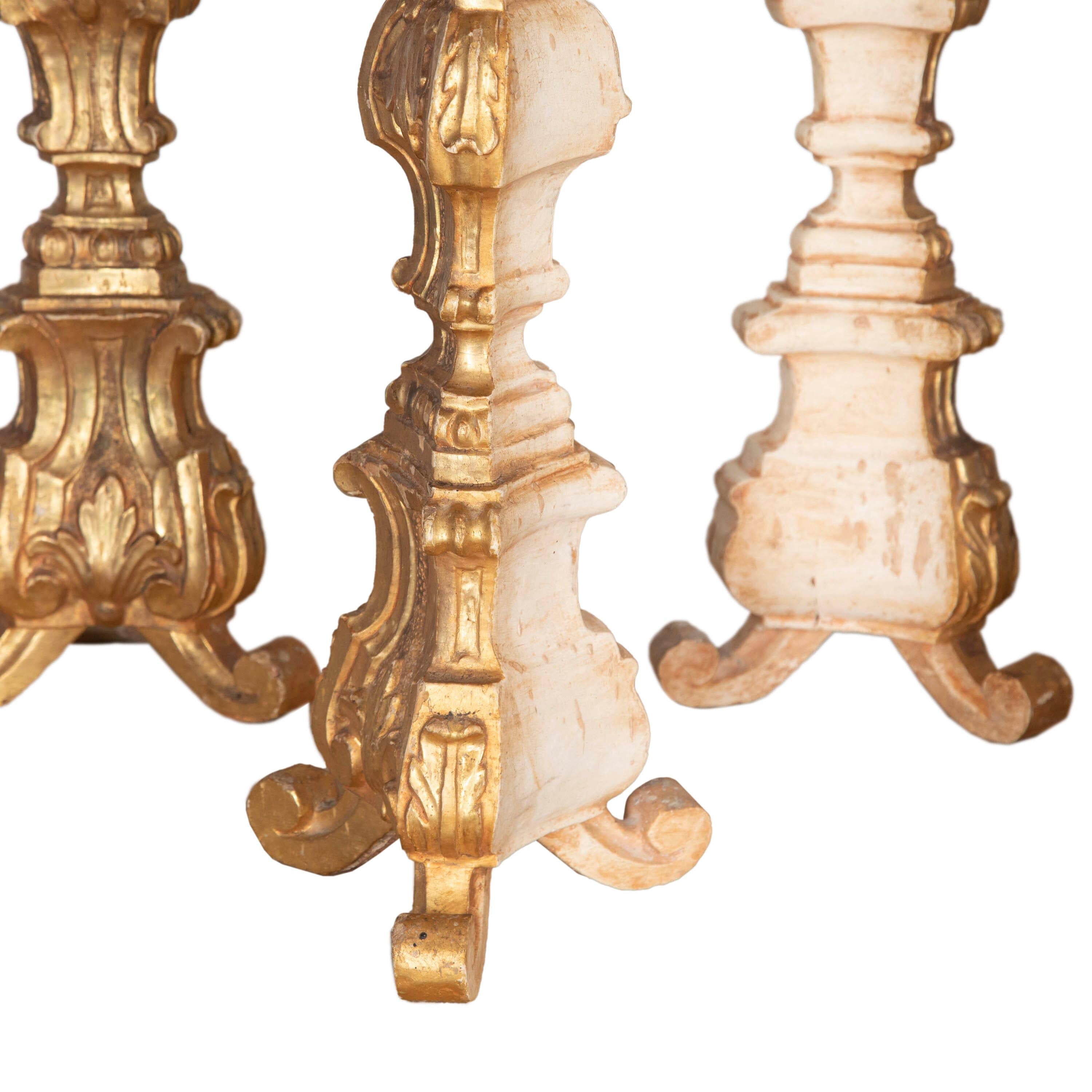 Collection of six 19th Century candlesticks. 
In carved wood with decorative detailing and gilding throughout.