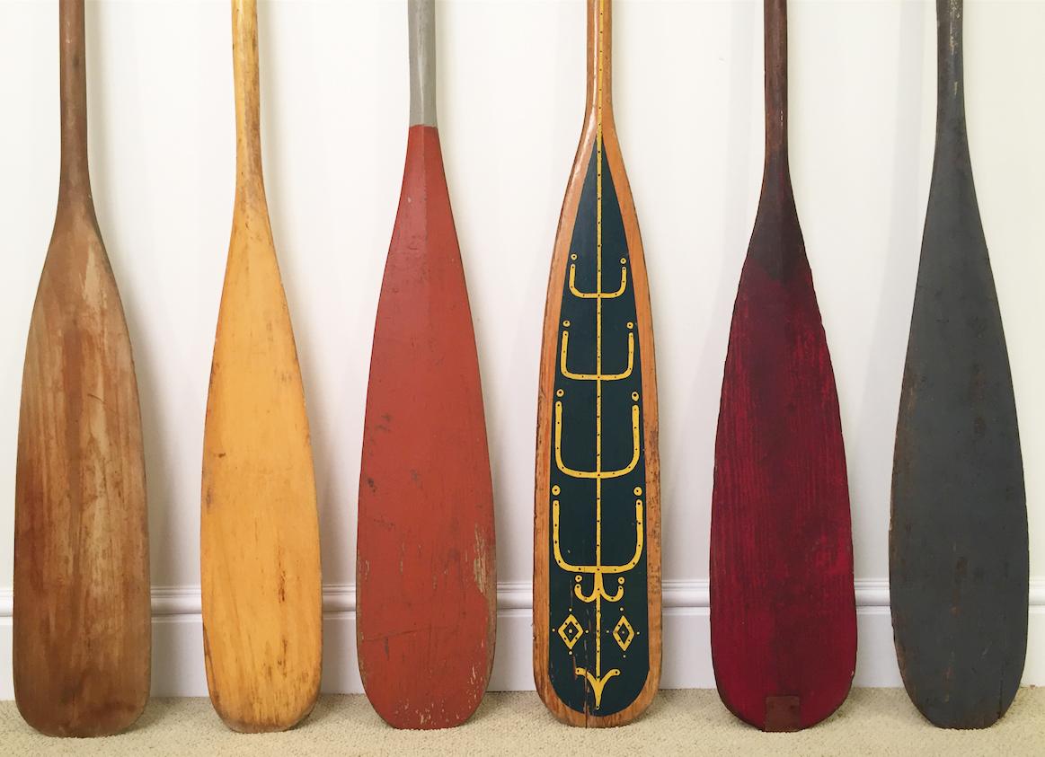 Collection of eight antique wooden canoe paddles with original painted surfaces, circa 1920-1950. Great for a summer or beach house. Range in size from 57 inches to 60 inches in height and 5.5 to 7 inches in width.