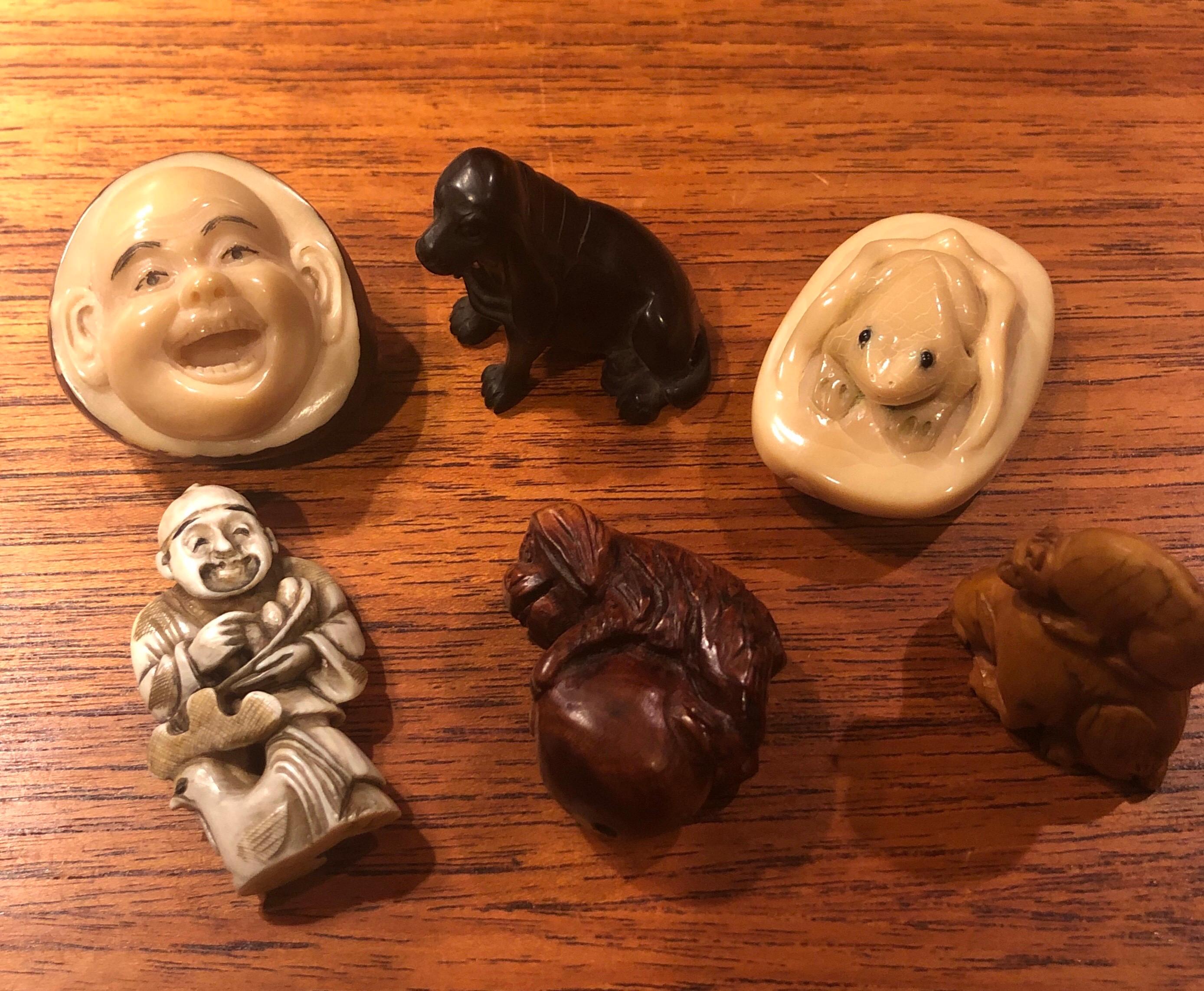 Fun collection of six Japanese netsukes made of variety of different materials including: wood, resin bone and a toggle nut, circa 20th century. There are two figurative netsukes and four of the pieces are highly detailed animals. Some of the pieces