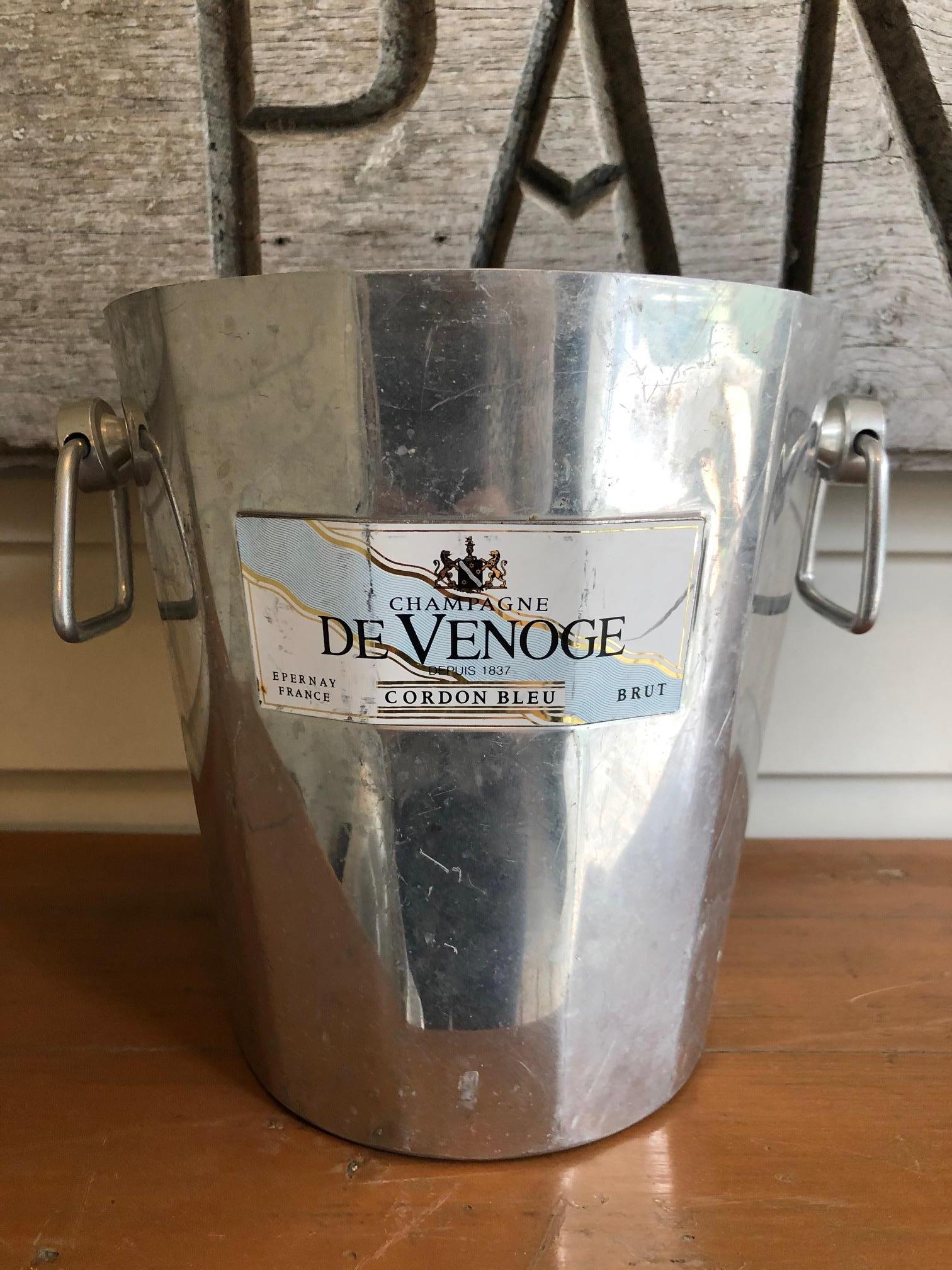 Wonderfully graphic vintage French champagne buckets wine coolers, most stamped Argit, having silver aluminum with Classic tapered shape, some with knob handles on either side. Most have decorative ribs near the bottom and top and graphic black and