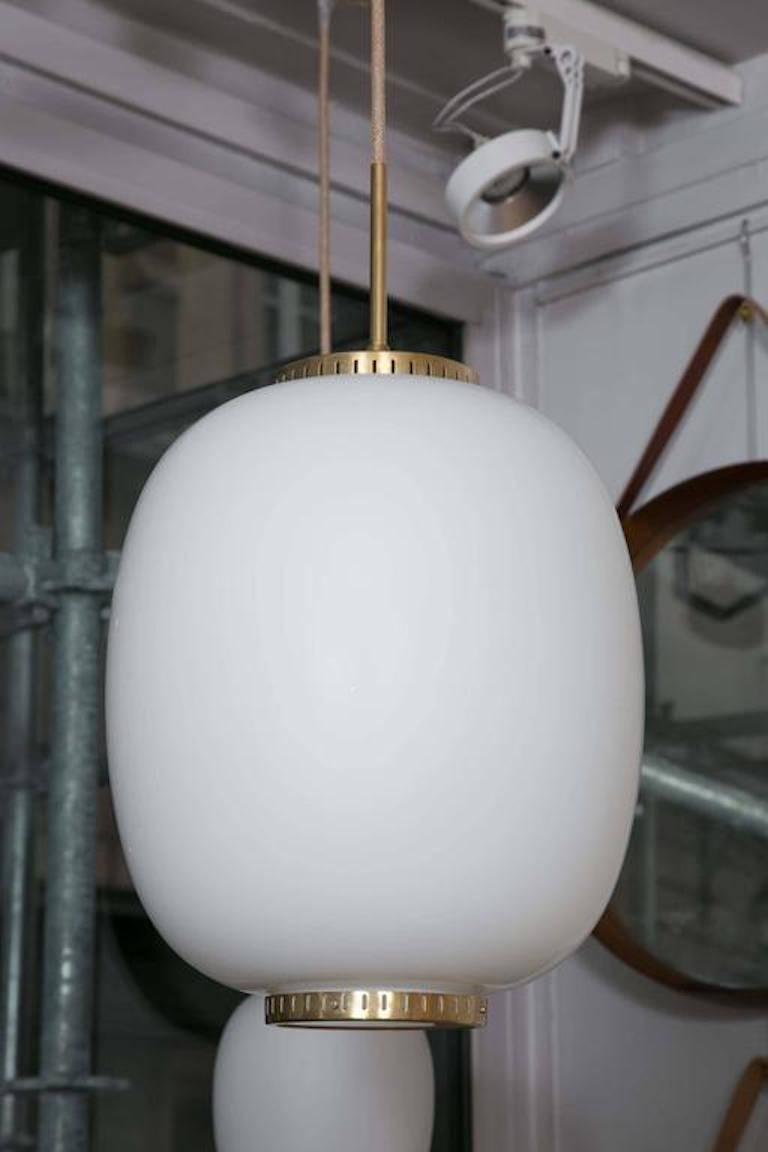 Collection of 8 opaline glass and brass ceiling fixtures. 
Seven now available, including 1 very large fixture (largest size, hard to find).
See dimensions below 
By Bent Karlby for Lyfa. 
Denmark, late 1950s 

Various dimensions available: (Height