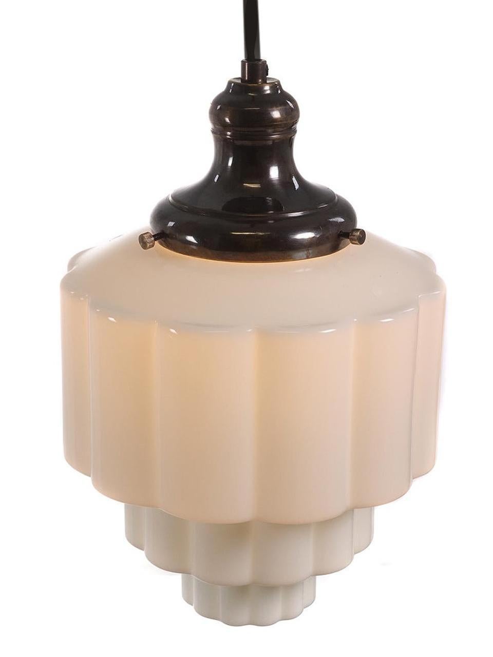 Sometimes these are called wedding cake or skyscraper shades. The style is totally Art Deco. What I like about these shades are the very useable size. The diameter is only 8 inches. It is white milk glass and the shade takes on the hue of the bulb
