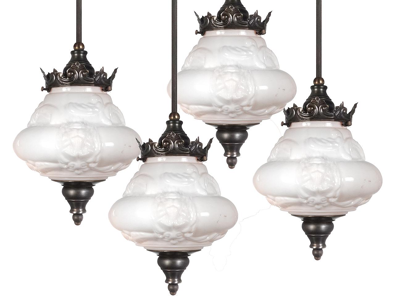We have a small collection of these rich looking pendents. They are priced per lamp so you can buy only one or the whole collection. The milk glass shade is ornate with a deep decorative pattern. It is crowned with metal work in stamped and turned