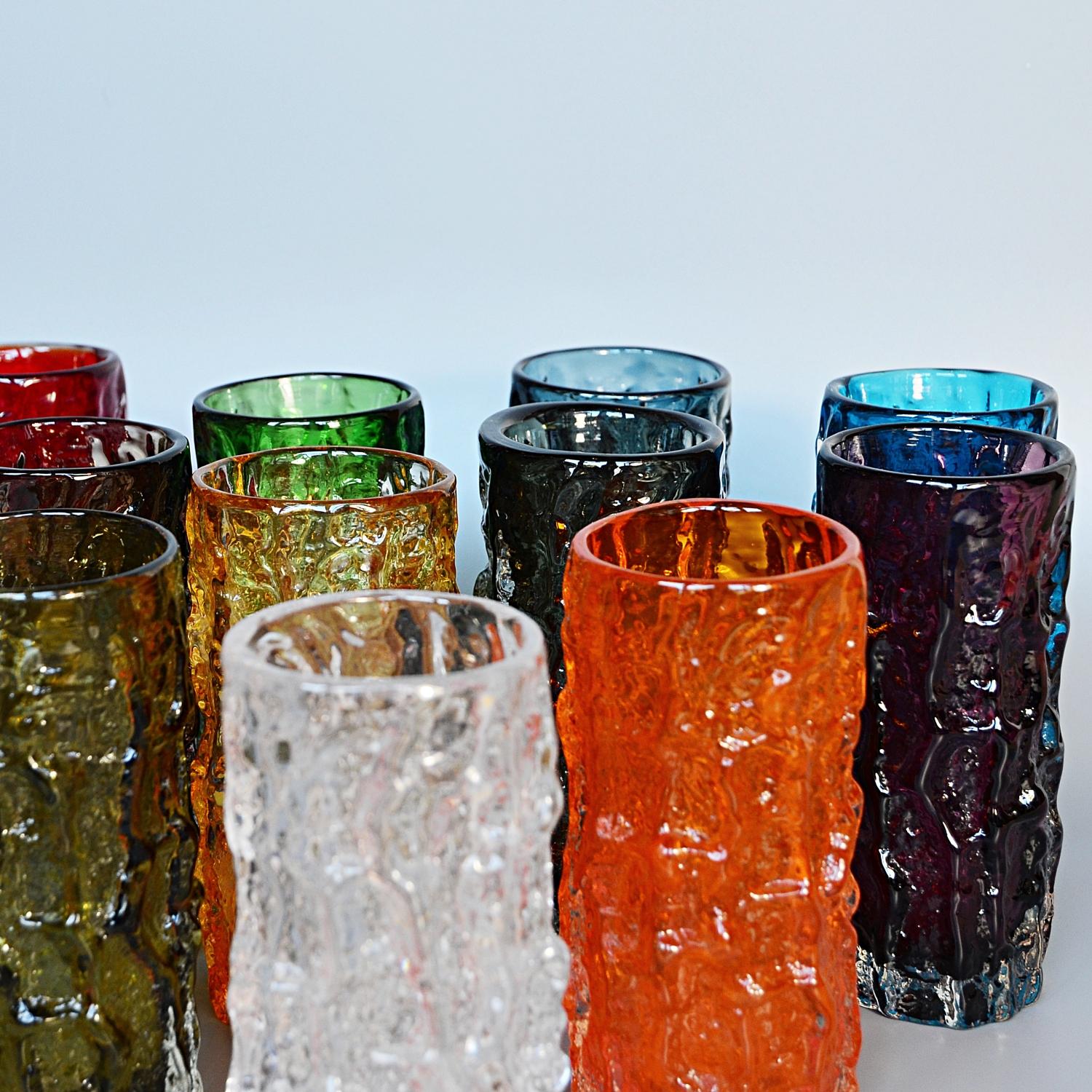A Collection of twelve textured Cylindrical Bark vases in various colors designed by Geoffrey Baxter for Whitefriars Glass Factory. 

Designer: Geoffrey Baxter (1922-1995)

Geoffrey Baxter was one of the most influential and significant British