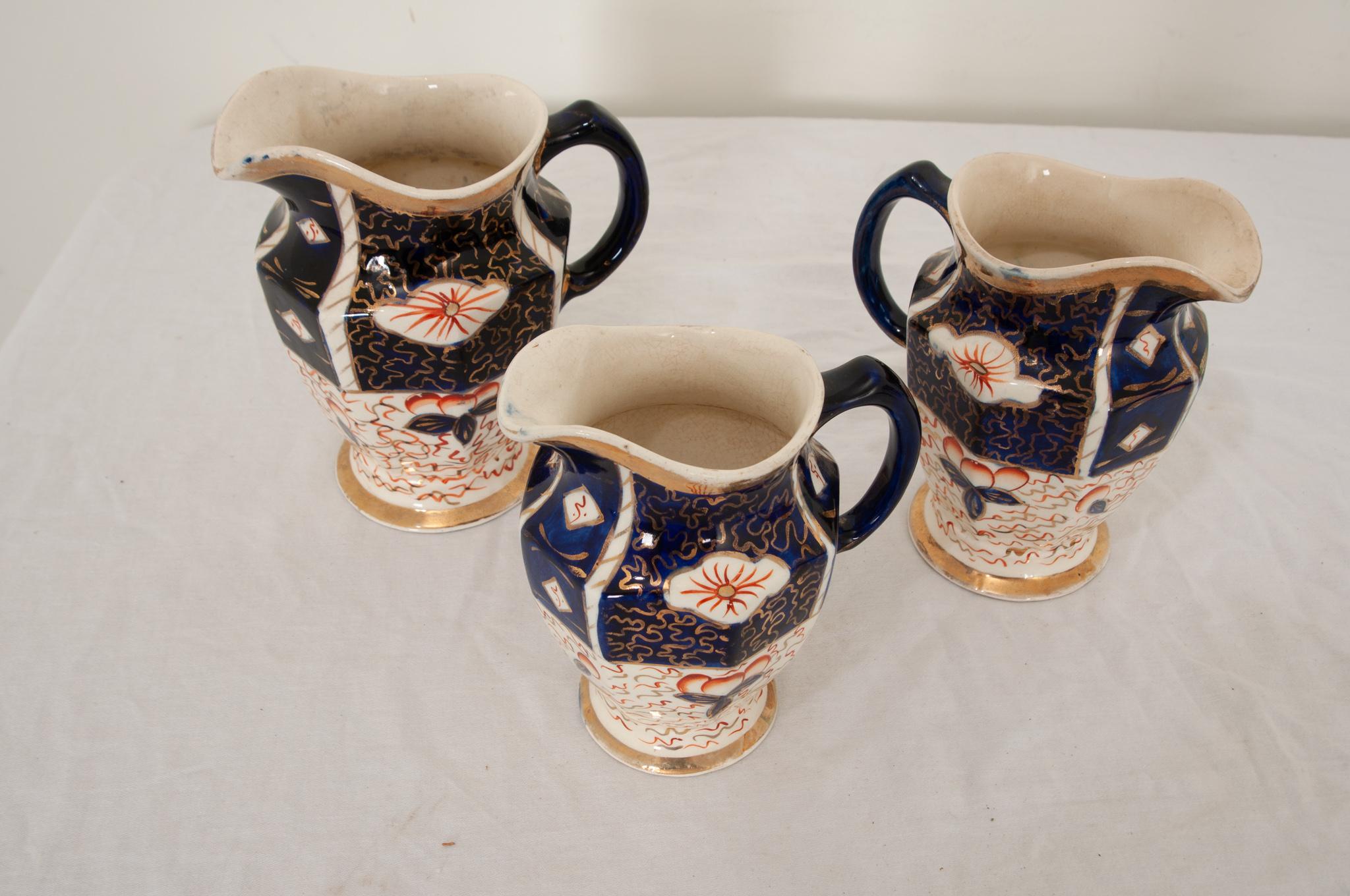 Fired Collection of Three 19th Century Aesthetic Movement Pitchers For Sale