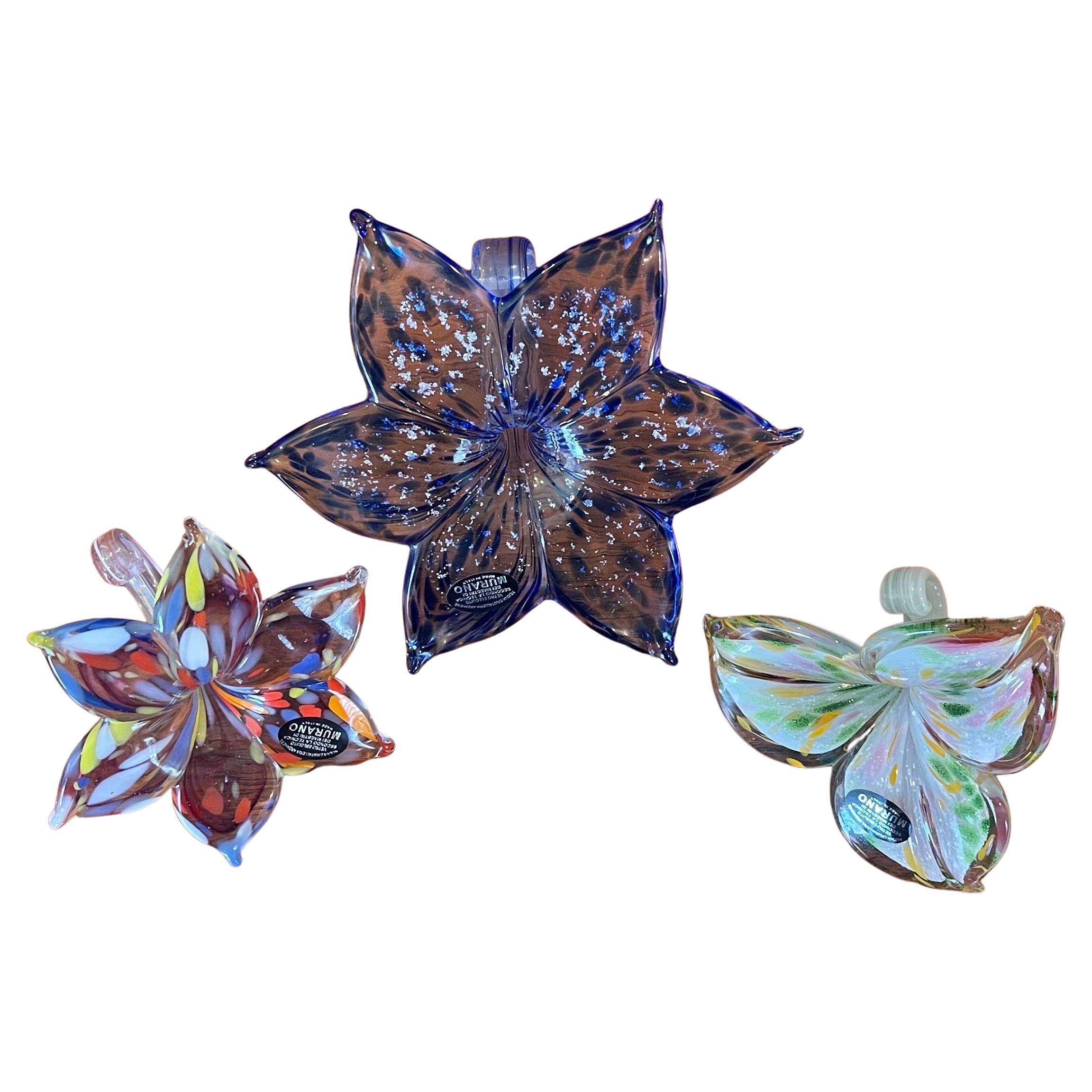 Stylish collection of three art glass flower sculptures by Murano Glass, circa 1980s. The flowers have wonderful color and are in very good condition with no chips or cracks.  They measure 7.5