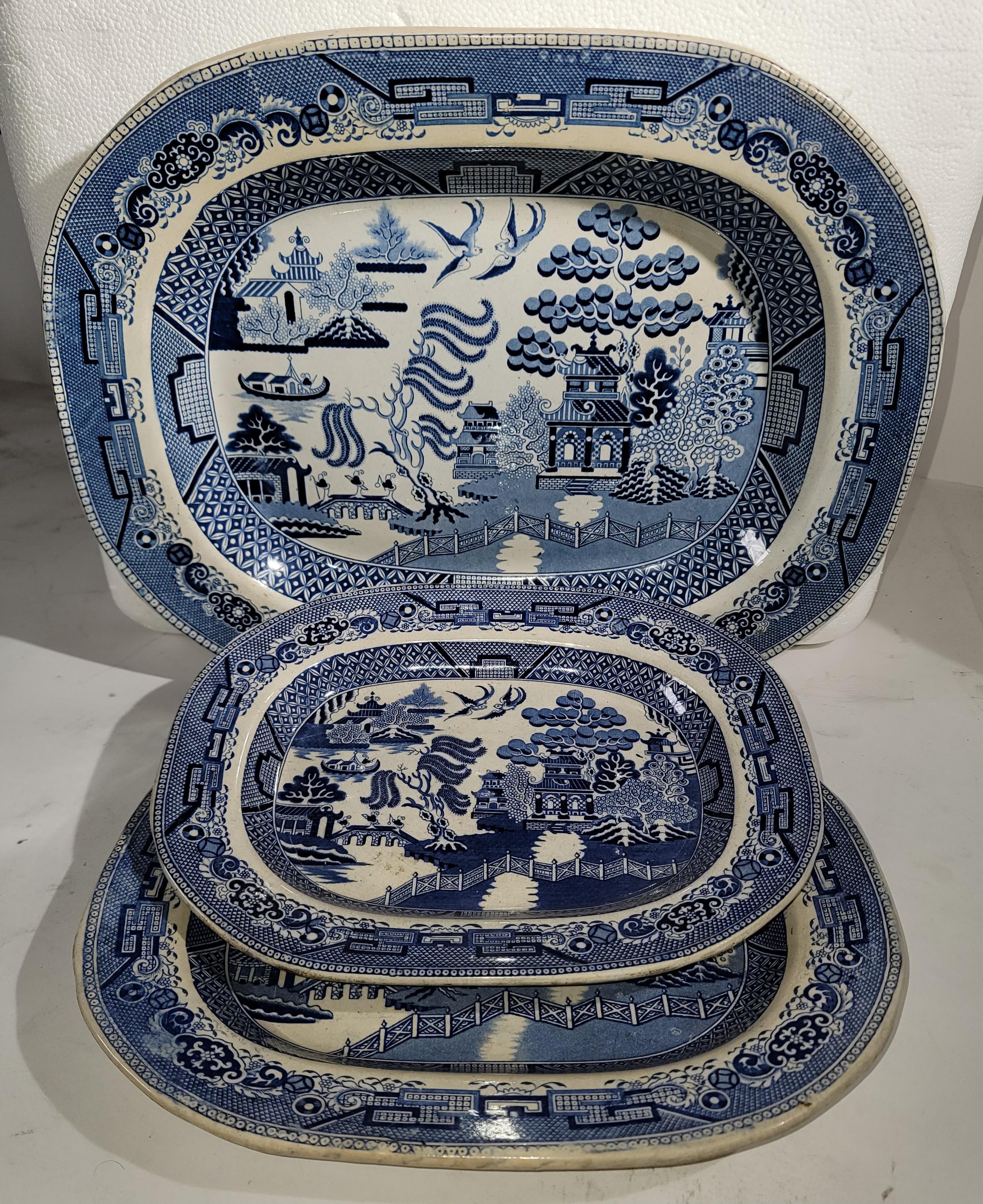 These early 19th Century English Blue willow platters are all in very good condition and stamped England with manufacture stamps. All in pristine condition with no chips or cracks.

Largest Platter measures - 14 x 17 
medium platter measures -11