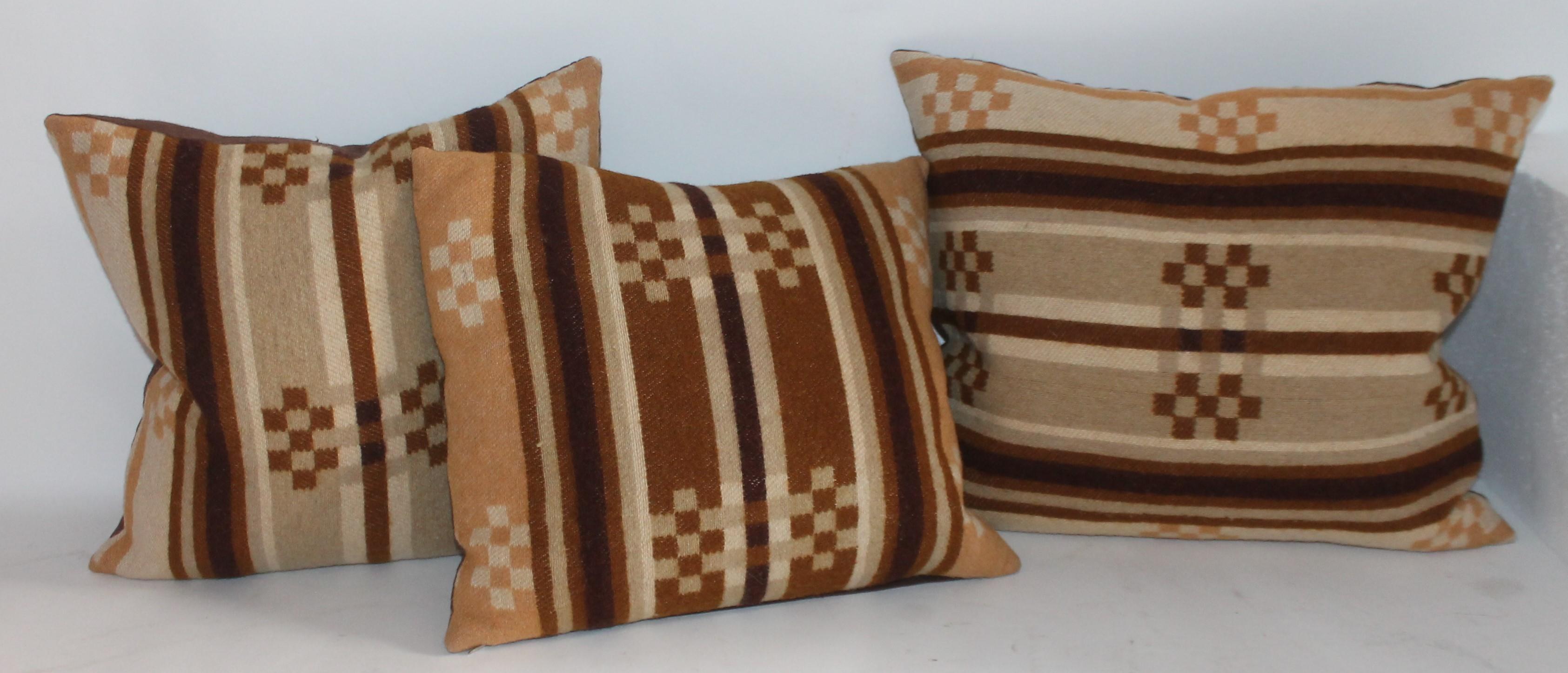 These 19th century horse blanket pillows are all different sizes and shapes. Great as one grouping on a sofa or bed. Largest is 16 x 18. Others are 15 x 15 and 14 x 15. Total of three pillows.