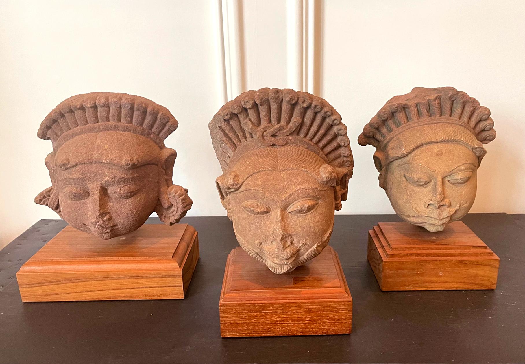 Archaistic Collection of Three Indian Sandstone Carved Heads of Deities For Sale