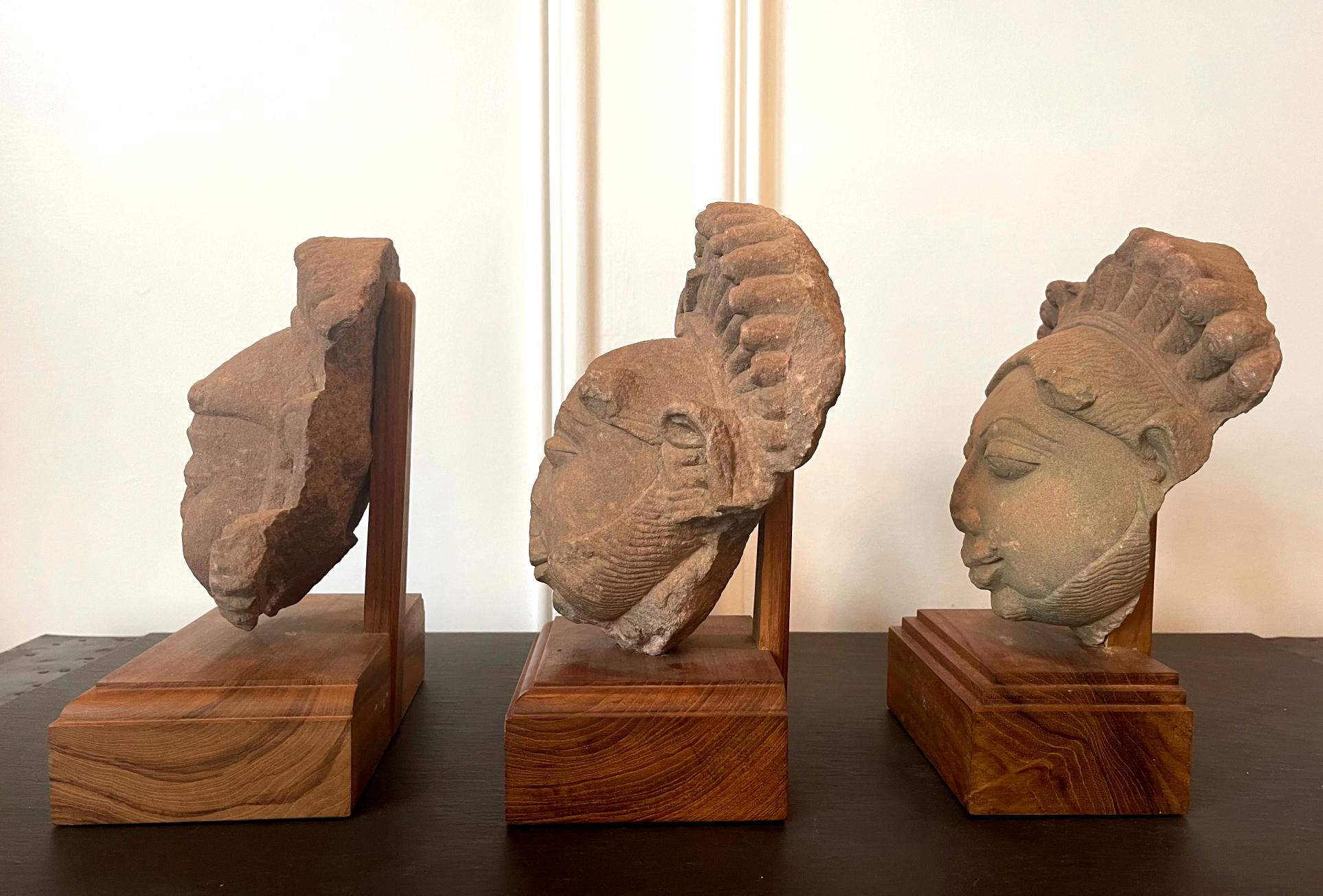 18th Century and Earlier Collection of Three Indian Sandstone Carved Heads of Deities For Sale