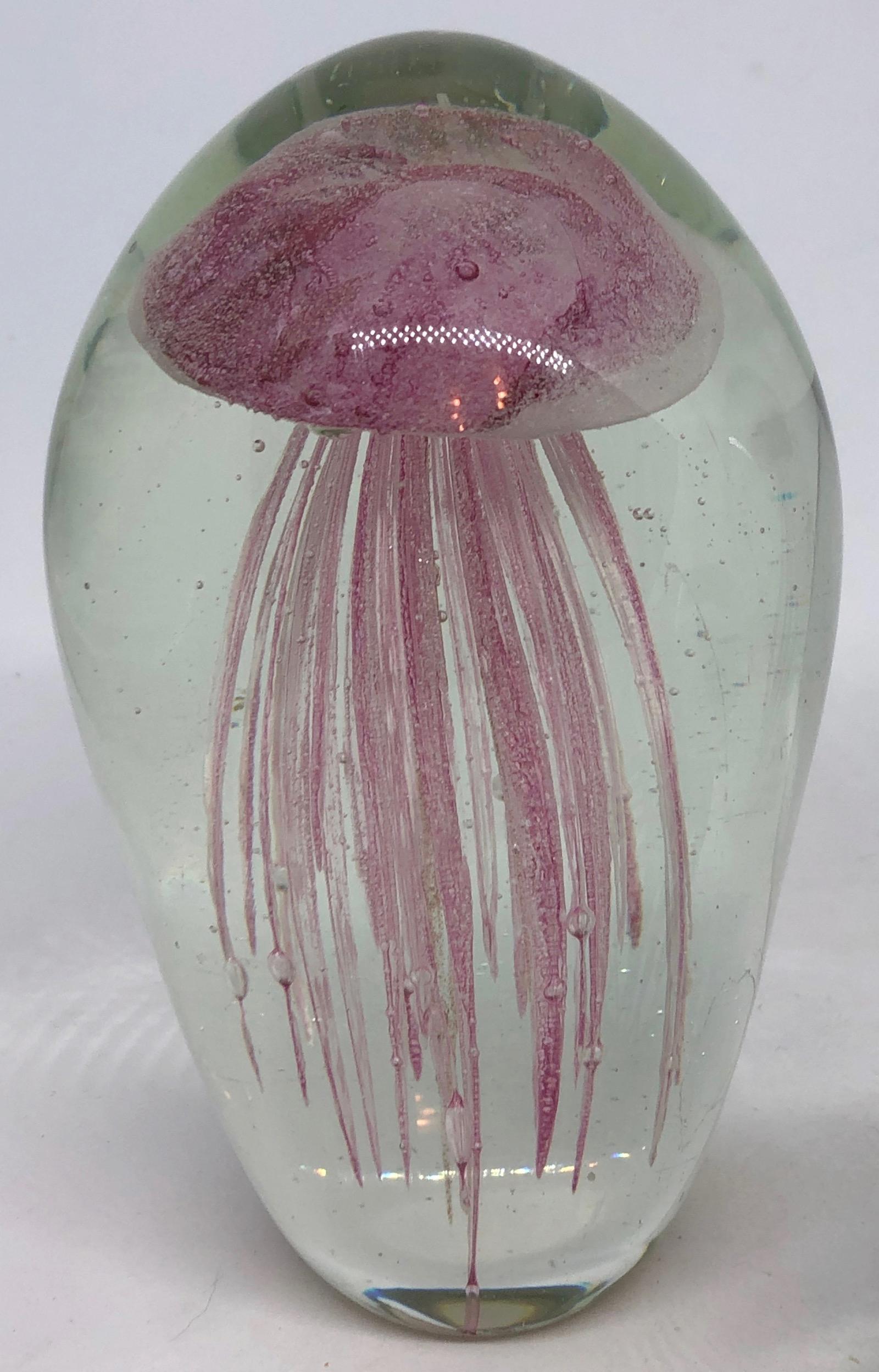 Beautiful set of three Murano hand blown aquarium design Italian art glass paper weights. Showing Jelly Fish inside, in different colors, floating on controlled bubbles. Colors are a dark pink, black and white and one in green. Tallest measure 6