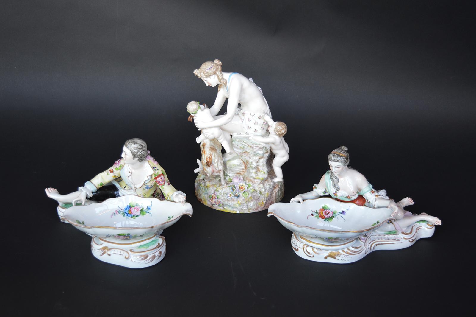Three Meissen figures. Two sweet meat dishes and a figure. Measures: 10