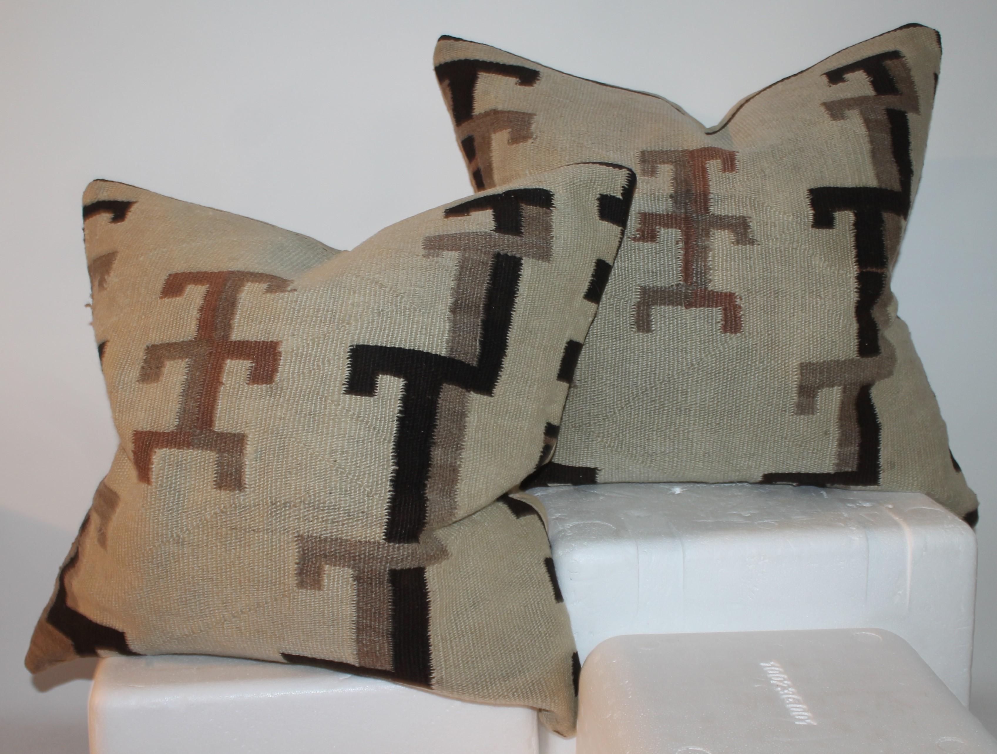 Collection of three Navajo Indian weaving pillows from a 19thc saddle blanket weaving.
These weaving pillows are as is condition with old repairs and liners inside of the covers. The backings are in tan cotton linen.
22x 22 x 7 large pillow 
22 x