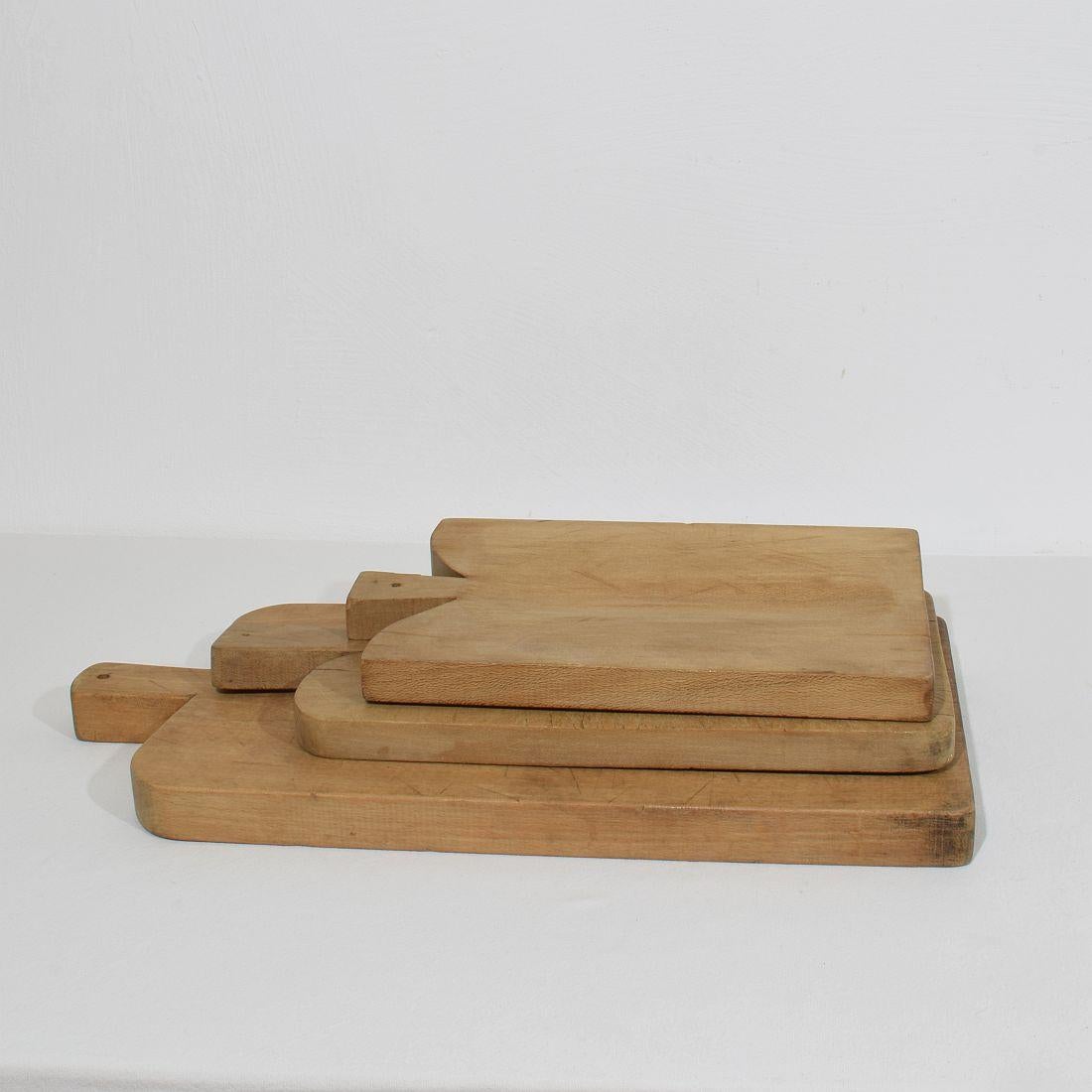 Beautiful  collection of three wooden chopping-cutting boards. Great statement on your counter-top,
France, circa 1850-1900. Weathered. Measures:H:35,5/55,5cm  W:22,5/27cm D:3/3,7cm . Measurement here below of the largest cutting board. More