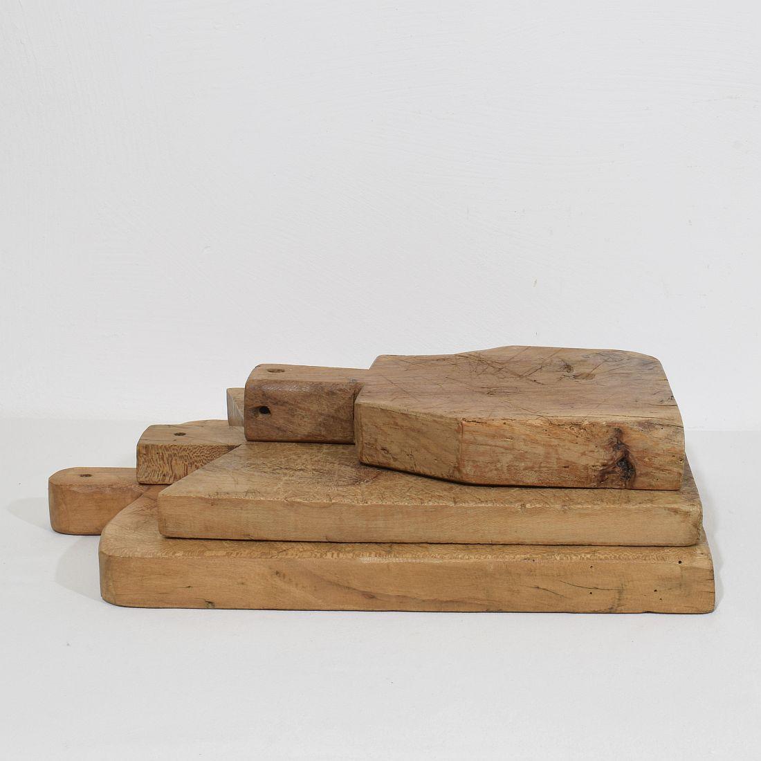 Beautiful  collection of three wooden chopping-cutting boards. Great statement on your counter-top,
France, circa 1850-1900. Weathered. Measures: H:33,5-52cm  W:24-33,5cm D:3,5-5,5cm . Measurement here below of the largest cutting board. More