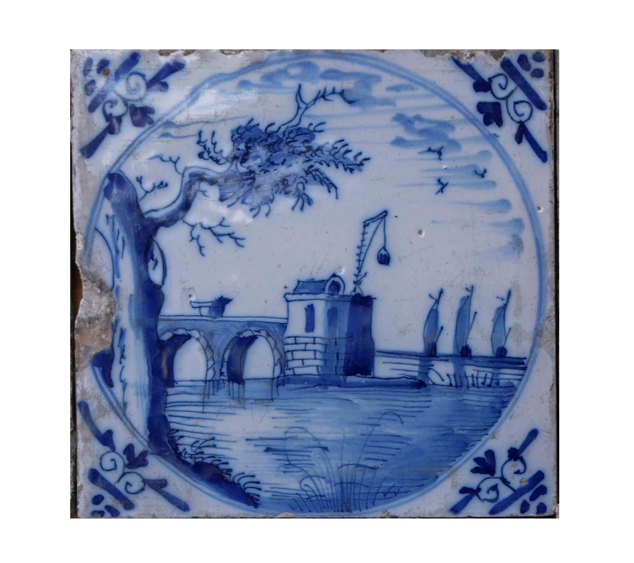 A collection of twelve antique Delft Tiles. A set of tiles depicting Dutch scenes with windmills, maidens and soldiers. All of which are in expressive blue colouring on a white background. Each image provides a wonderful unique illustration.