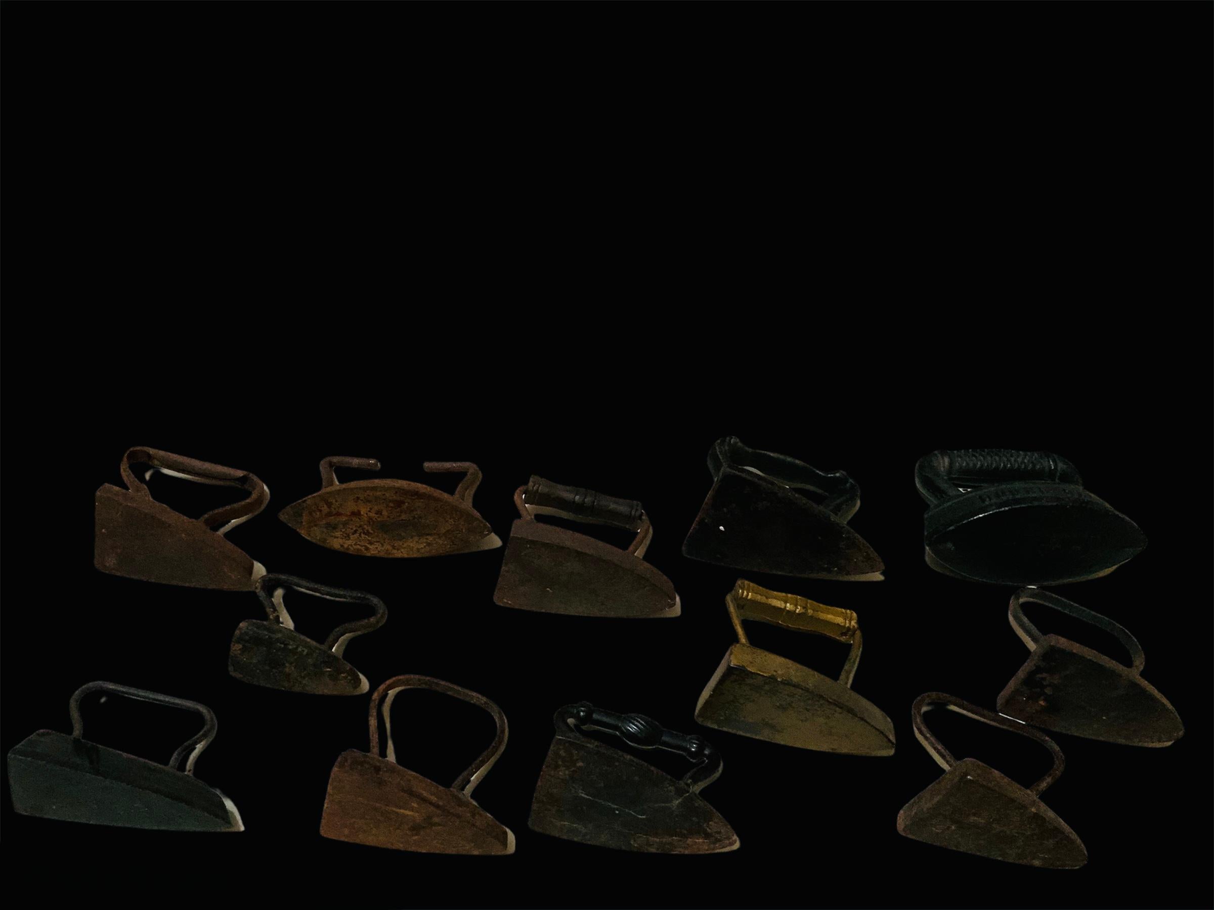 This is a collection of twelve antique miniatures sad irons/flat cast irons. Some of them are identified by numbers ( 0, 1 and 2). Another ones are hallmarked Dover, USA and Stoves and Ranges. There is one that has a symbol of a heart in the center.