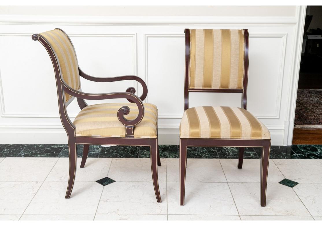 Collection of twelve Kindel neoclassic style sleigh back dining chairs featuring two arm chairs and ten side chairs with scrolled top rail with tightly upholstered back and seat on tapered saber legs. Arm chairs have wonderful scrolled arm