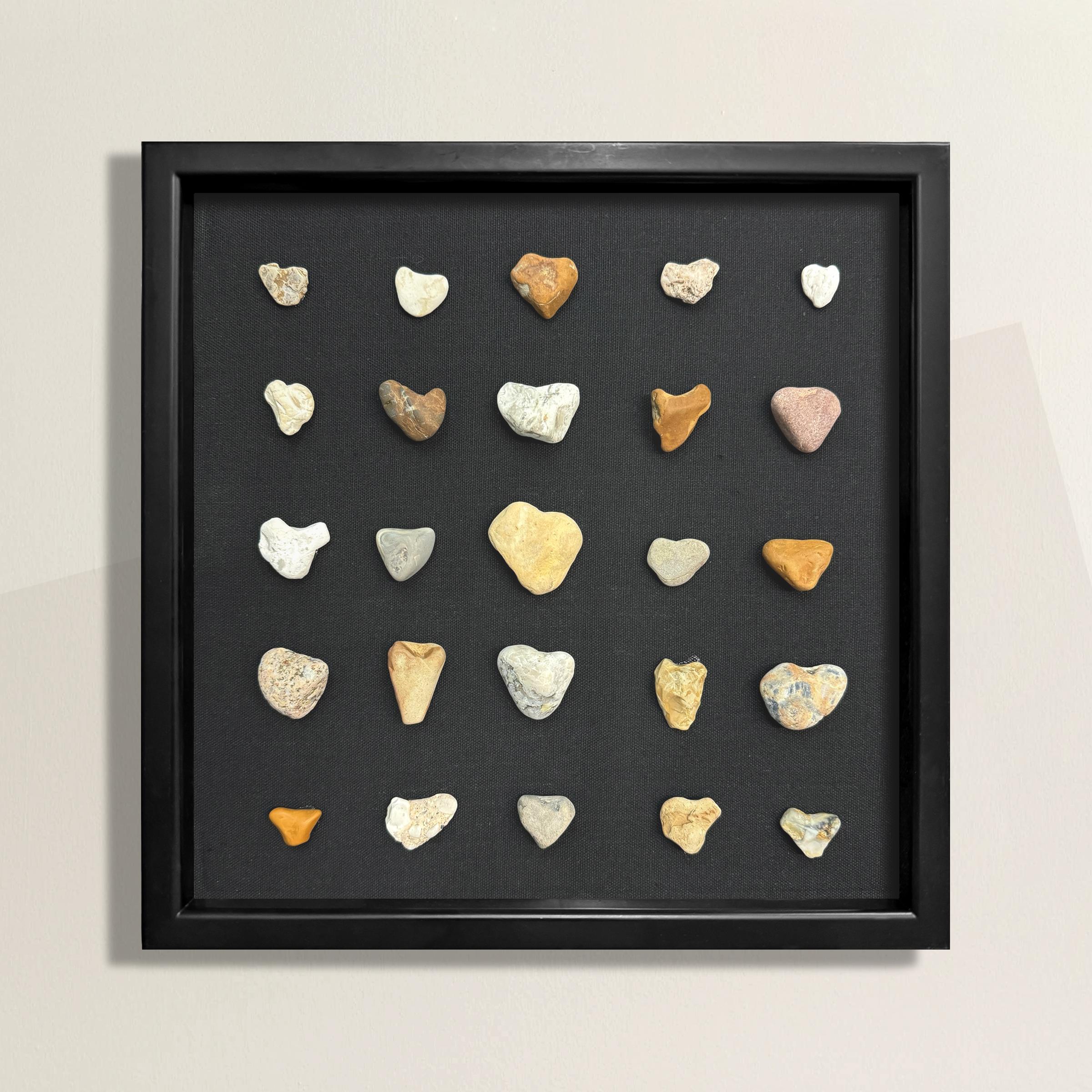 This collection of twenty-five heart-shaped stones, gathered from various beaches of Lake Michigan in Wisconsin, is a beautiful testament to the natural wonders found along its shores. Each stone, carefully collected over many trips, is as unique as